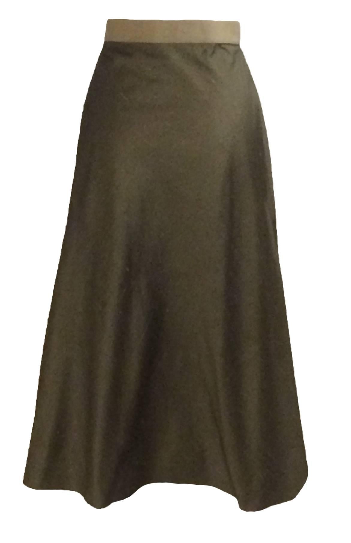 
Chloe green silk midi skirt with grosgrain band at waist. A-Line cut and gold zip detail at side. 

100% silk. 

French 42, approximate US 10. 
Waist 29