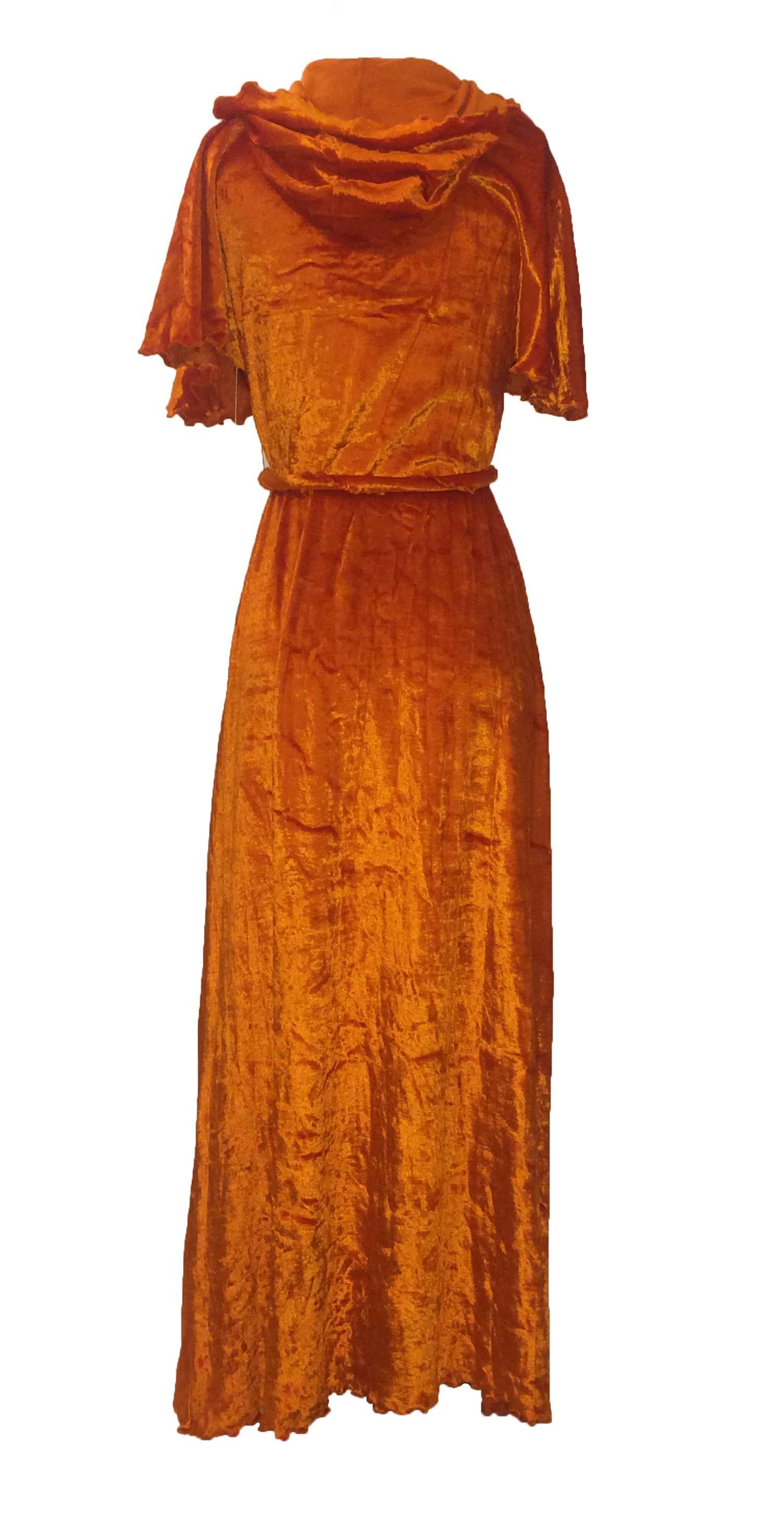 Stephen Burrows Loungewear orange velour robe. Lettuce edge at hood, sleeves, and hem. Includes belt made of twisted velvet with exposed lettuce edge. 

65% acetate, 35% cotton.

Size 10. Would best fit XS/S.

Bust 32