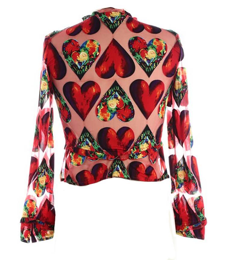 Gianni Versace Couture pink heart print blouse from the Spring/Summer 1997 collection. Red & floral heart print inspired by Jim Dine. Ruffle detail at neck, cuffs, and waist. Button front with Versace Medusa logo buttons.

100% silk.

Size IT