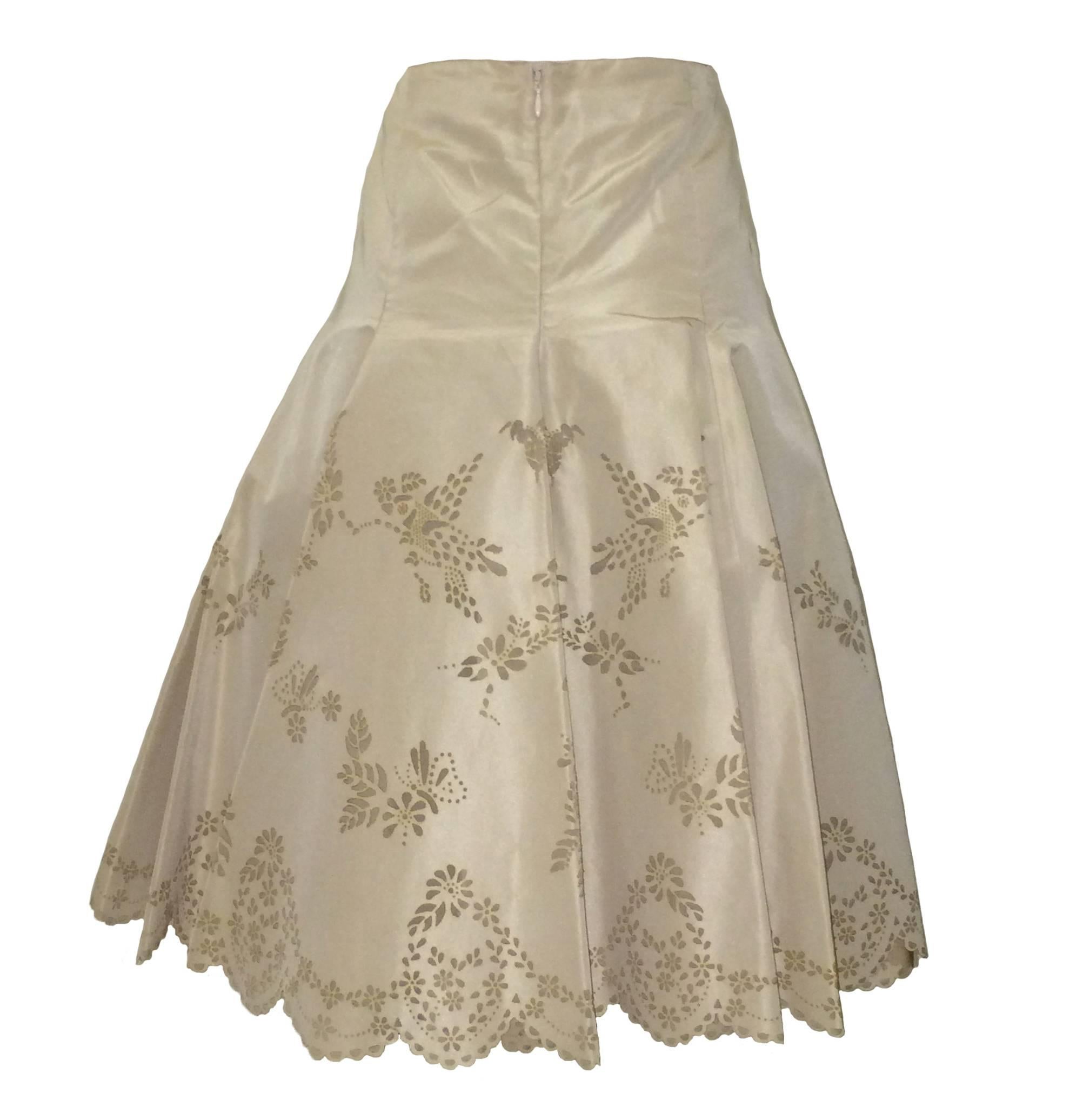 Alexander McQueen Spring 2005 laser cut skirt in dark cream. Laser cuts create florals, hummingbirds, and butterflies, as well as a lovely scalloped edge. Fitted hip flares into full skirt. Back zip & hook and eye.

Was shown in the McQueen Spring