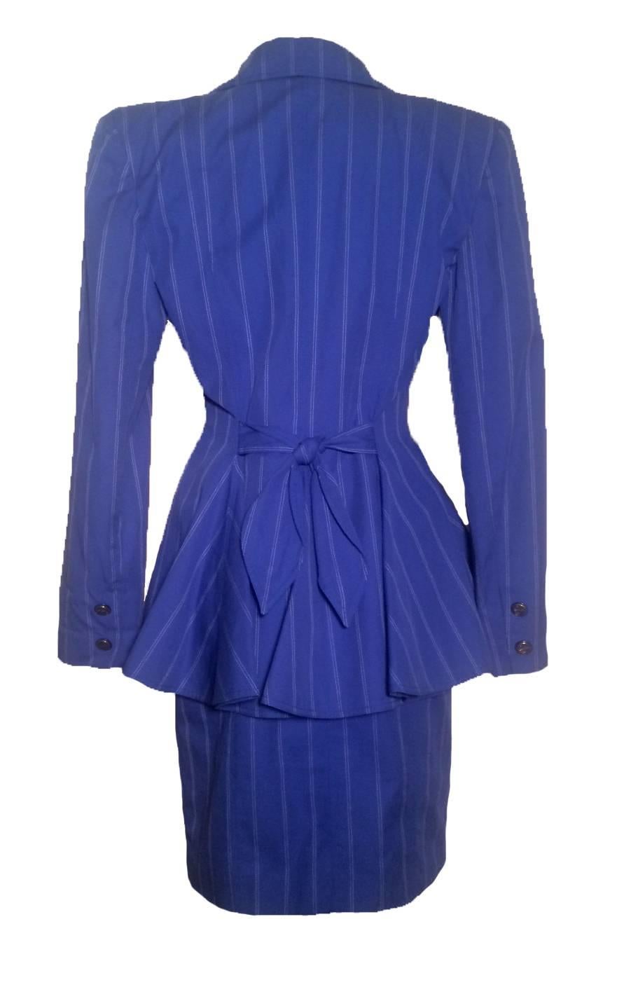 Vintage 80’s Patrick Kelly Paris blue suit with white pinstripe detailing. Anchor motif buttons at skirt waist, padding at shoulders. Skirt has zip and button front and two side pockets. 

95% cotton, 5% polyester. Both pieces are fully lined in
