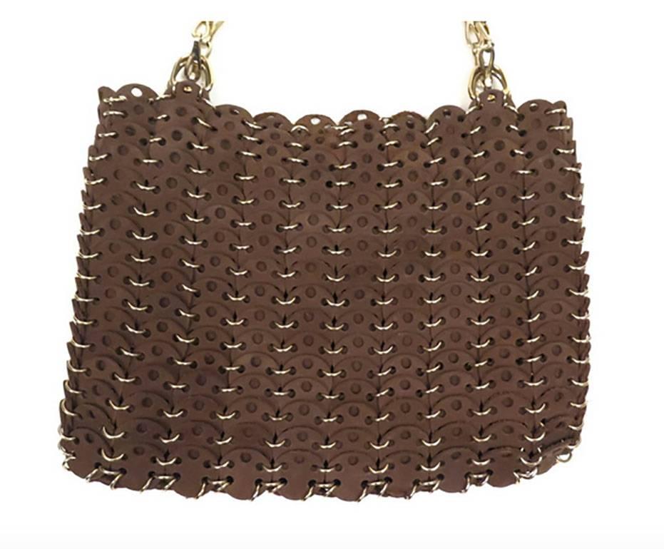 Paco Rabanne chocolate brown suede purse featuring Rabanne's signature discs connected by small metal loops. Chain link strap can be worn doubled as a shoulder bag, or single as a crossbody. Black leather interior. Magnetic closure.

8