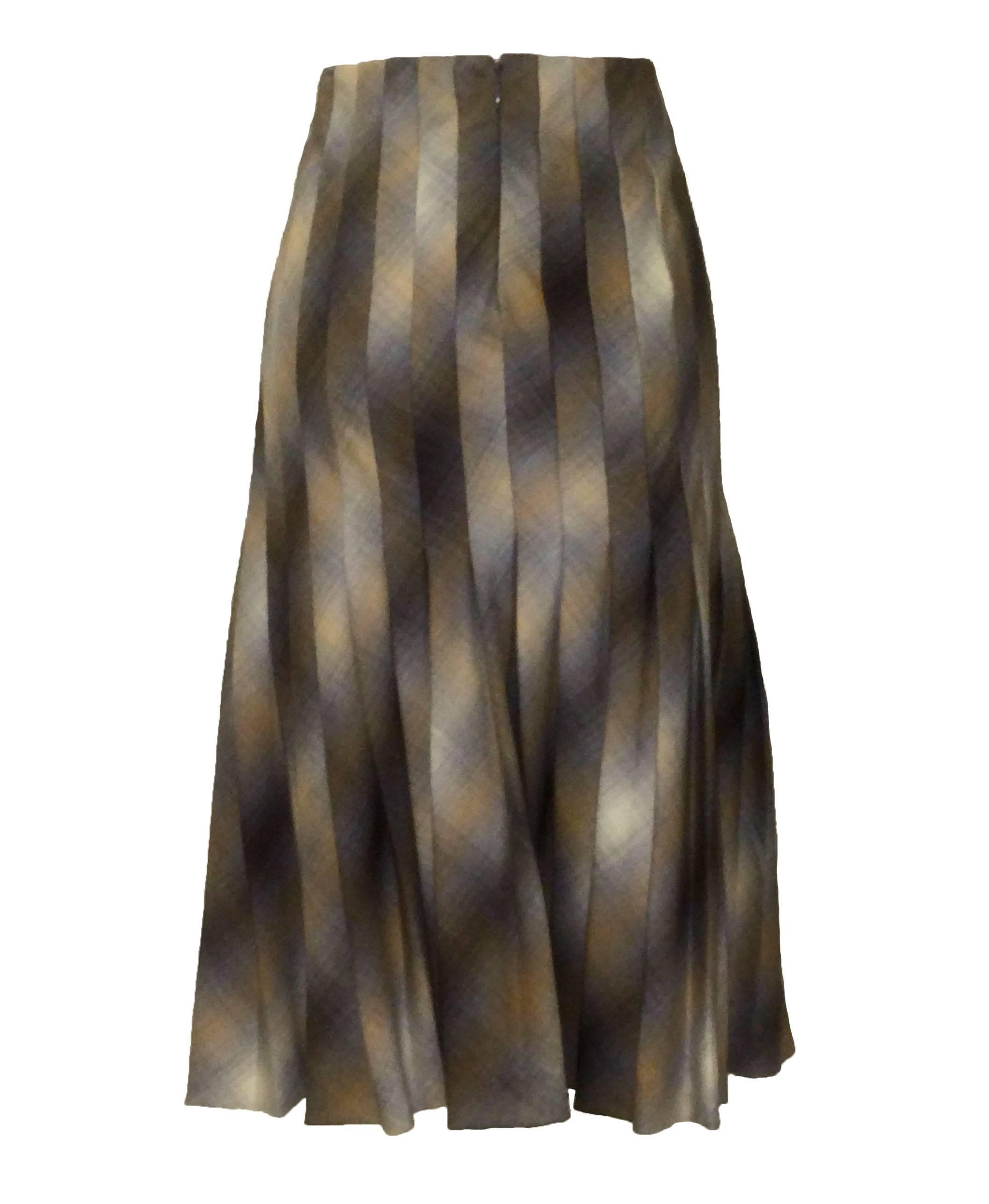 Alexander McQueen camel and grey plaid pleated wool skirt with textured leather buckle details and leather-covered safety pin embellishment from the Fall 2005 Hitchcock-inspired collection 'The Man Who Knew Too Much.