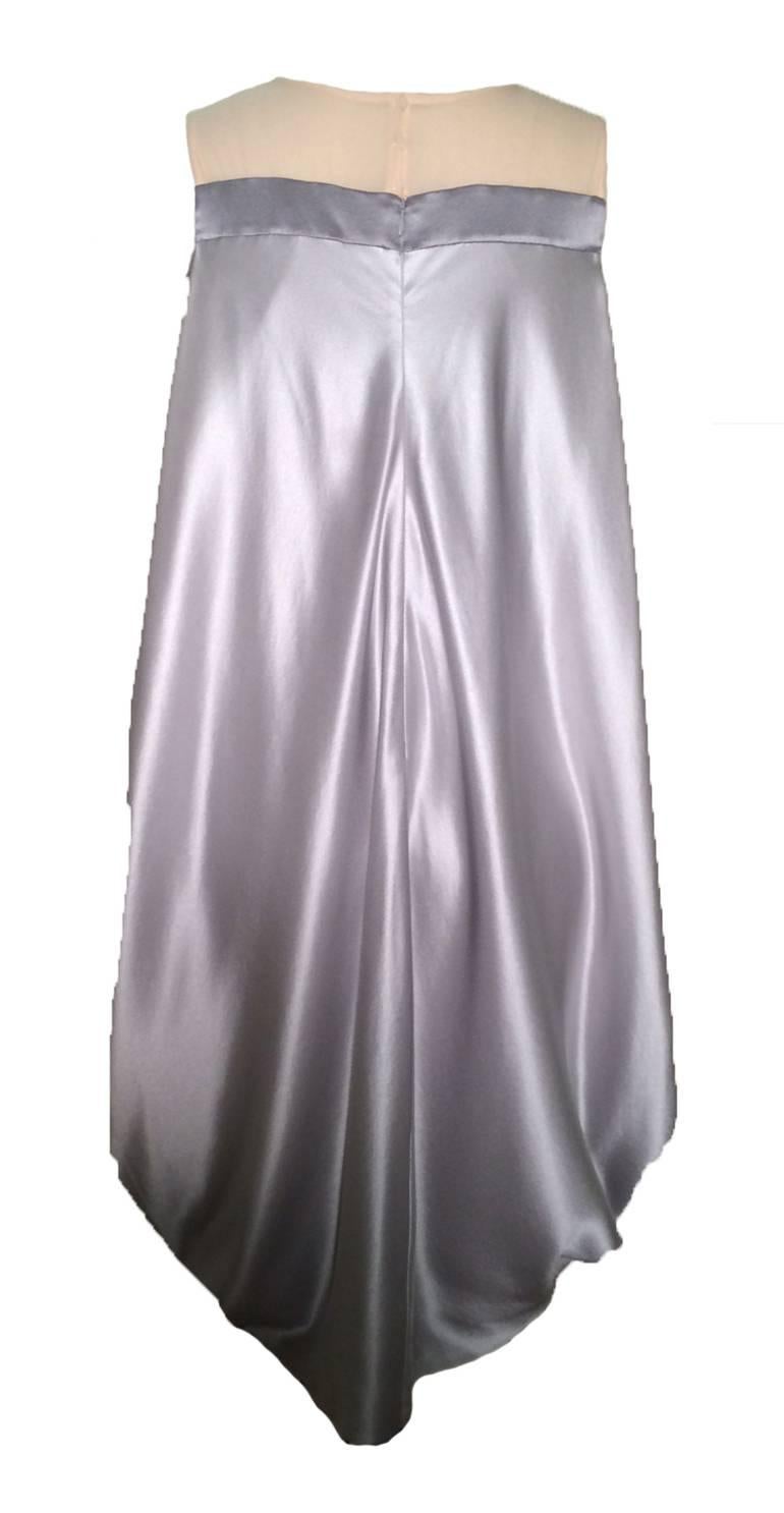 Alexander McQueen 2008 draped cocktail dress.  Slightly textured silvery grey silk with a semi-sheer nude at the top. Has pockets at side seams (still have the packing stitches in, will leave this up to the buyer to decide whether to open.)
Back zip