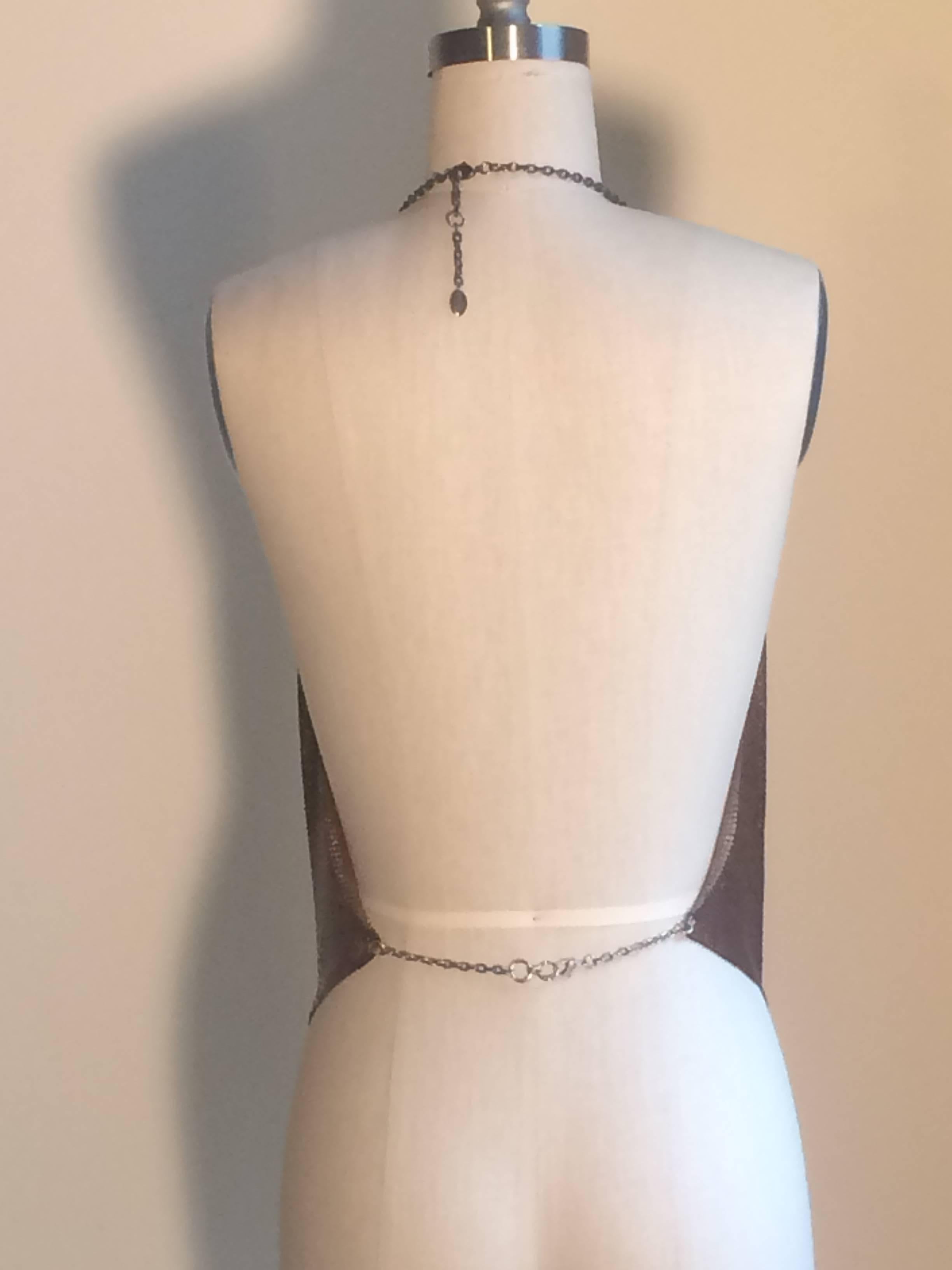 Paco Rabanne iconic signature hand made metal mesh backless halter tank in copper tone mesh with silver ring detail at bust. Chain fasteners at back neck and lower back. Labelled Paco Rabanne Paris at metal tag on neck chain.

Size 40, fits like