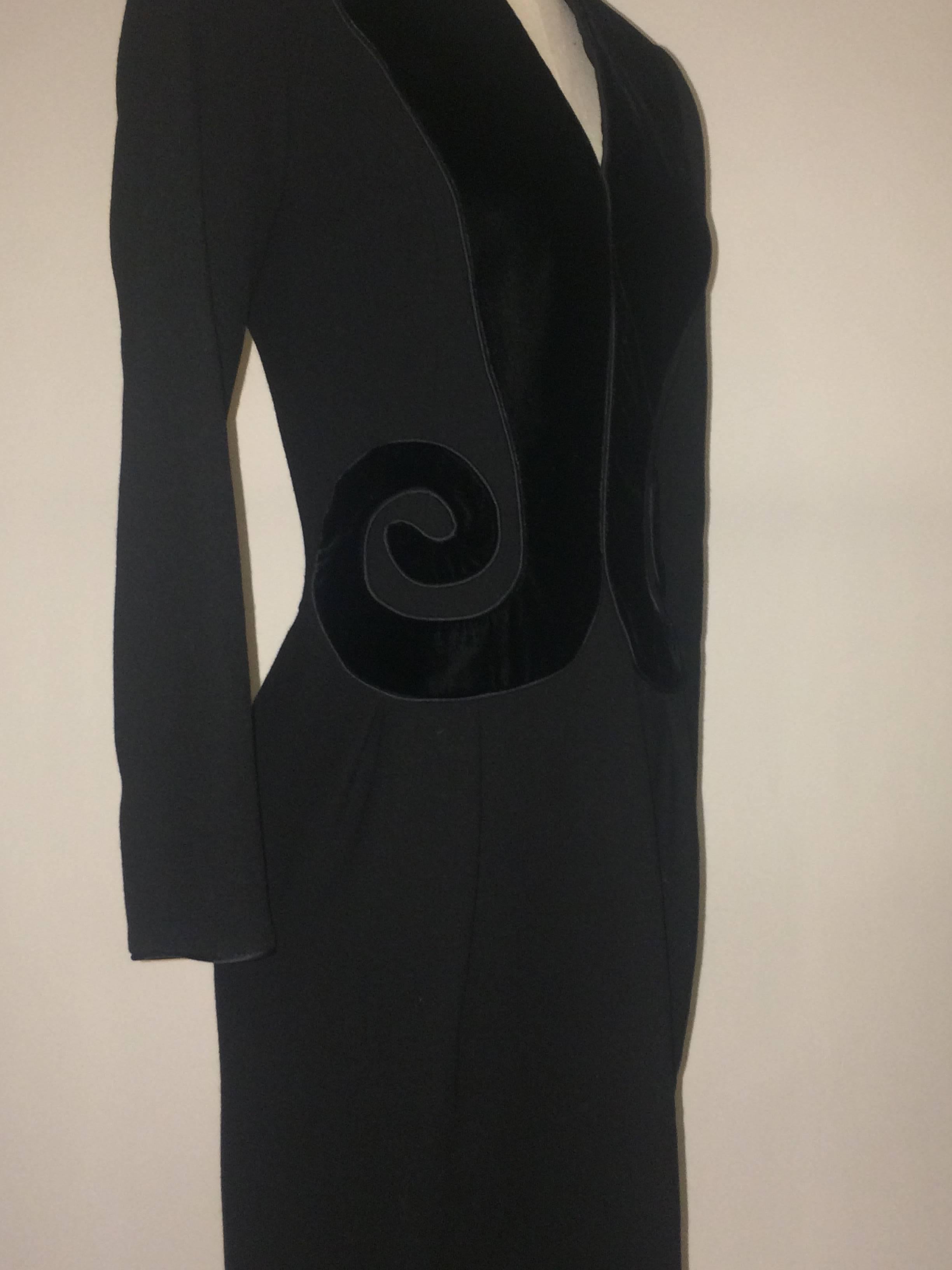 Oscar de la Renta early 1990s long sleeved black dress with back zip. Black velvet swirls at front and padded shoulders give the dress a bit of a Schiaparelli vibe.

Made in USA. 

Content unknown-- heavier wool crepe?

Size 8. Runs small, see