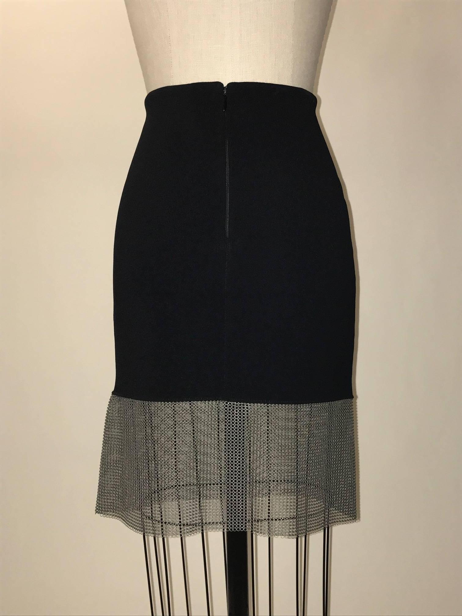 Paco Rabanne black knit body con pencil skirt with muted silver grey chainmail trim at hem. Back zip and hook and eye. 

95% viscose, 5% polyester.
Trim 100% brass.

Made in Italy.

Size FR 38, approximate US 6/8. See measurements. Stretchy,