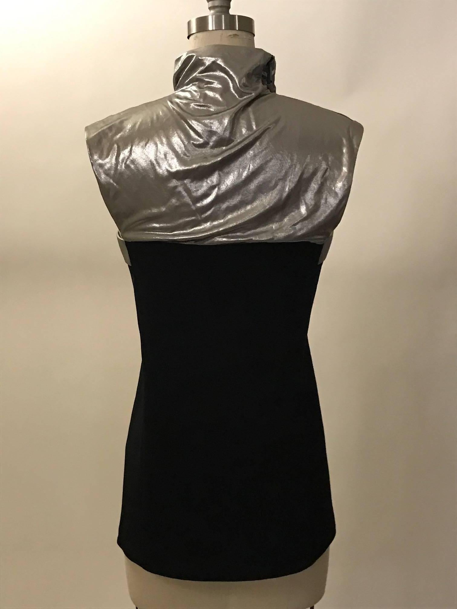 Paco Rabanne recent collection black sleeveless fitted top with draped silver metallic detail at chest. Black zip at one side of shoulder/neck. 

Fabric 1: 80% triacetate, 20% polyester.
Fabric 2: 100% viscose.
100% silk lining at top.

Made in
