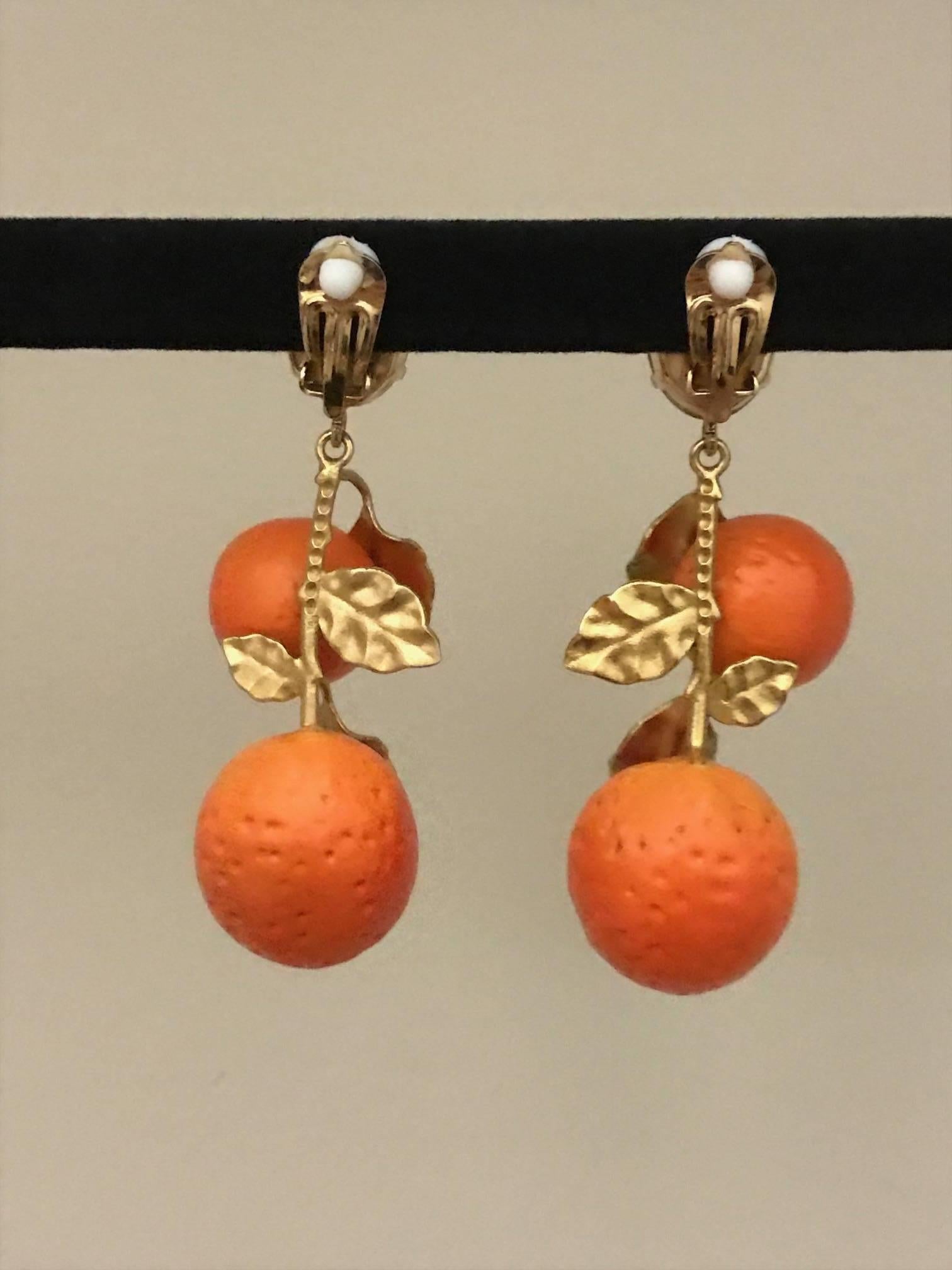 Dolce & Gabbana summer 2016 gold tone brass drop earrings featuring pale beige crystal tops and hanging textured resin oranges with green painted leaves. 

Clip on.

Signed Dolce & Gabbana at backs.

Made in Italy. 

Approximately