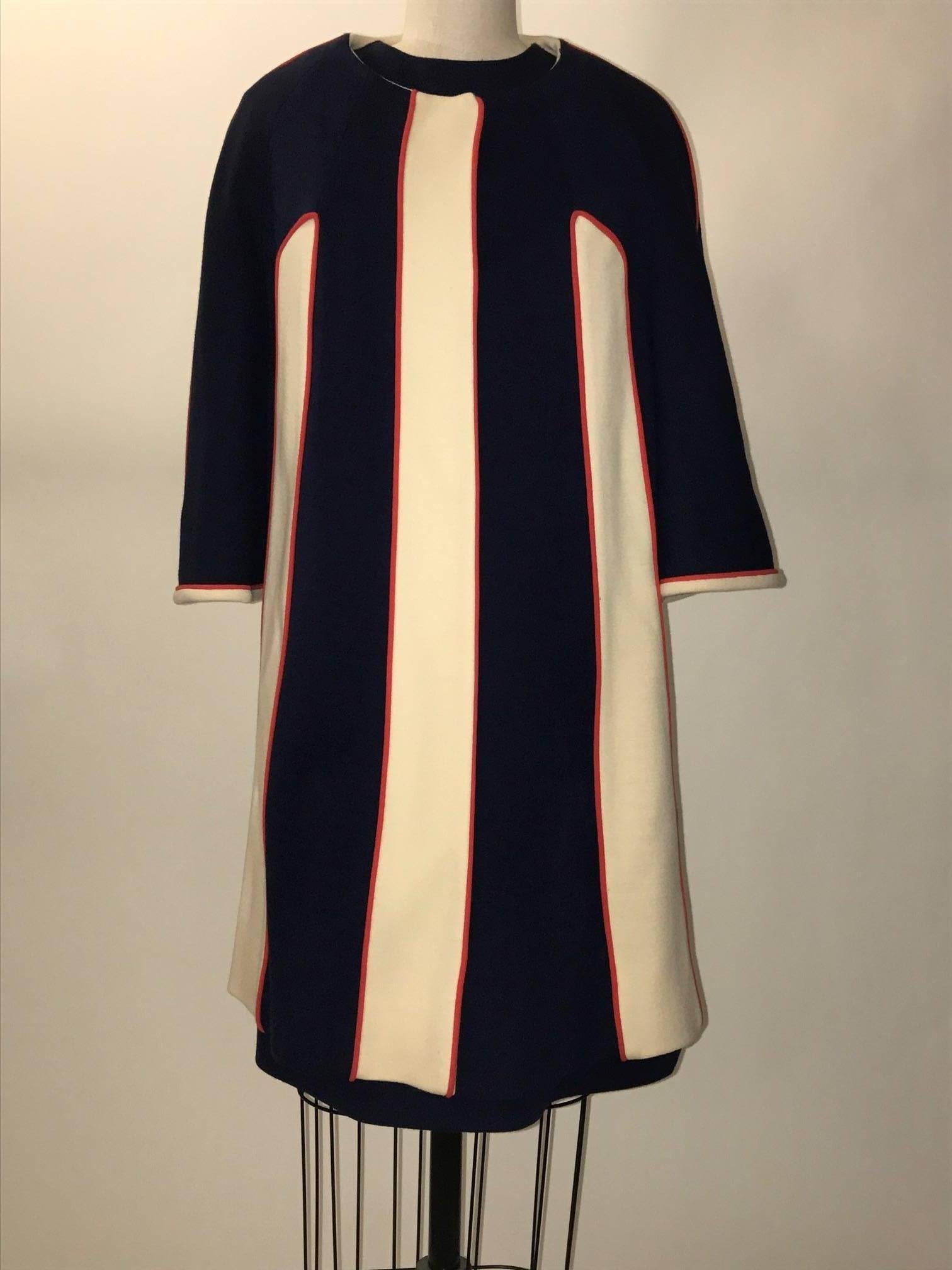 Vintage 1960's Lilli Ann by Adolph Schuman knit swing coat and sleeveless shift dress ensemble in navy and cream with red piping. Coat has mid length wide sleeves and fastens with four snaps at front. Dress fastens with back zip and hook and
