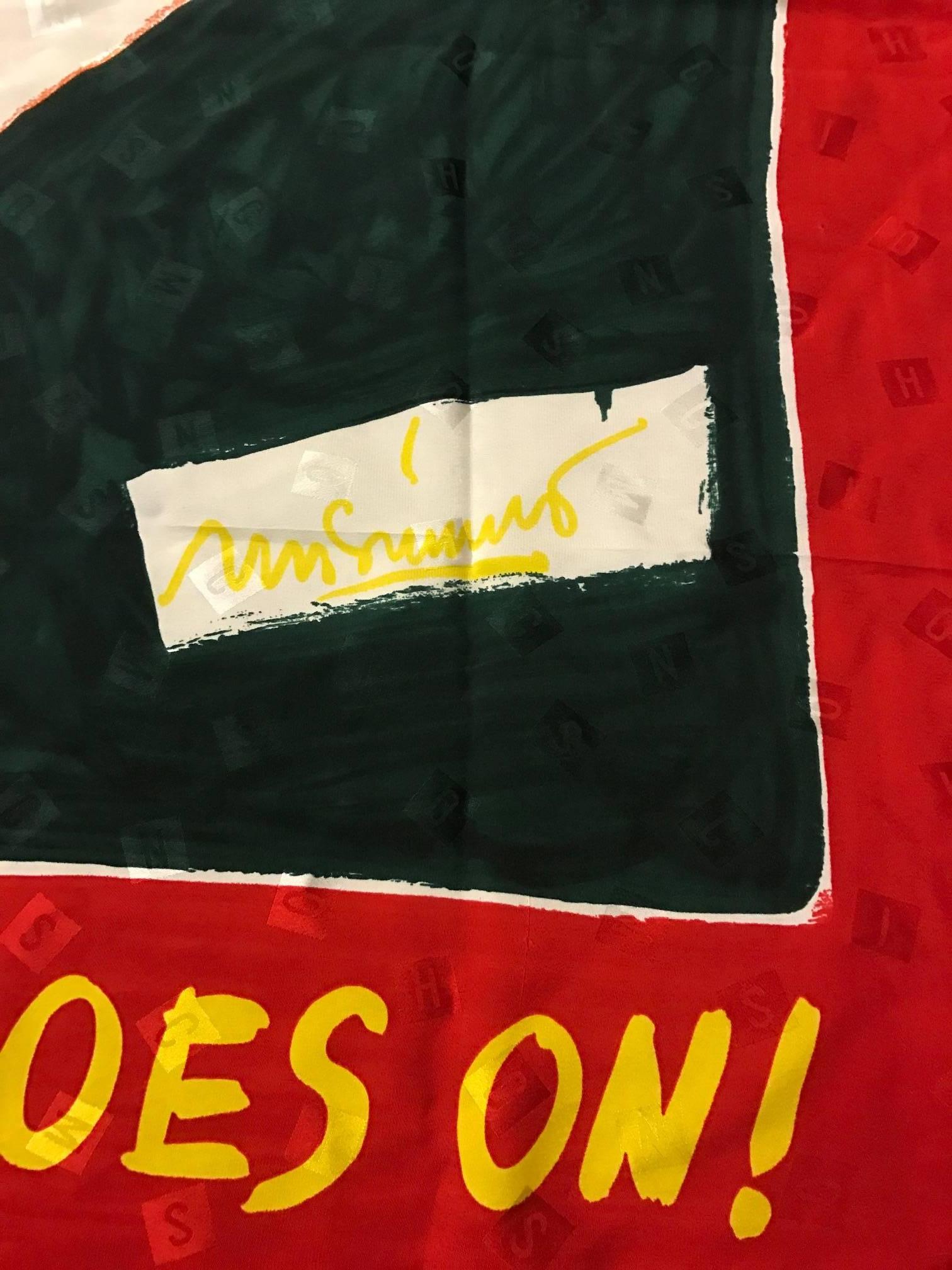 Vintage 1980s Moschino red silk marching dove scarf. Reads 'The Peace Goes On' above and below the olive branch holding dove, which is rendered in a crayon and watercolor effect. Small squares throughout spell out M-O-S-C-H-I-N-O. 

100%