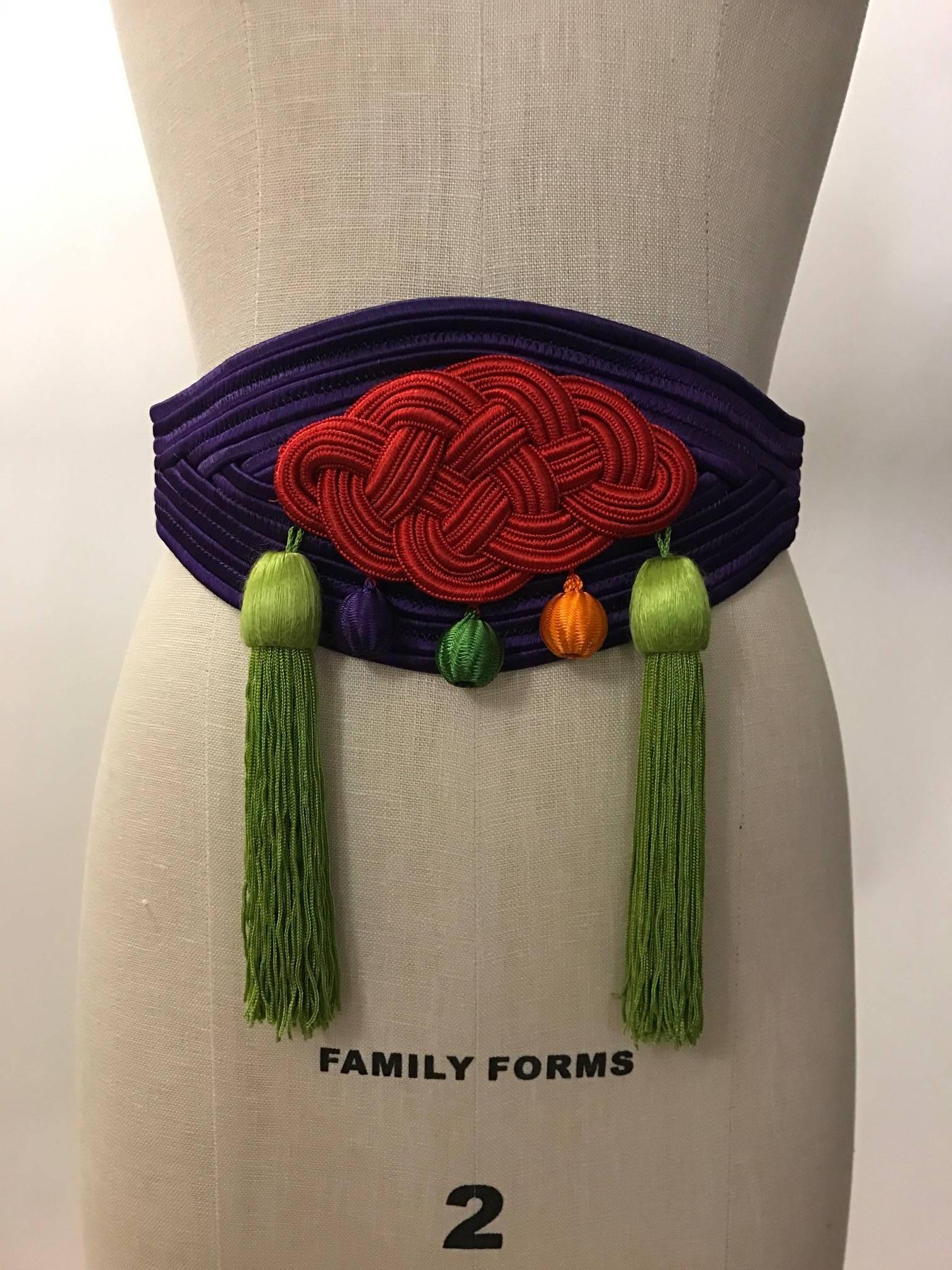 Yves Saint Laurent Rive Gauche vintage purple belt with red, purple, green, and orange multicolored embellishments. Fastens at back with snap and hook.

Best fits around a 26