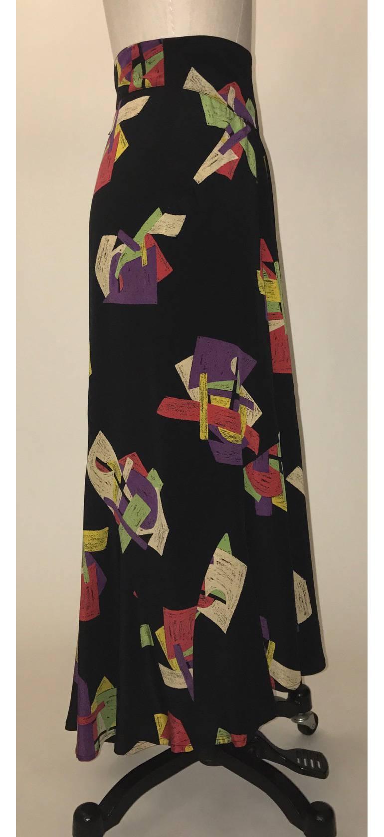 Karl Lagerfeld vintage 1980s black silk maxi skirt featuring a multi-color abstract print. Convenient pockets on each side. Hem dips a little lower at back. Fastens with back zip and four hooks at waistband.

100% silk.

Made in France.

Labelled