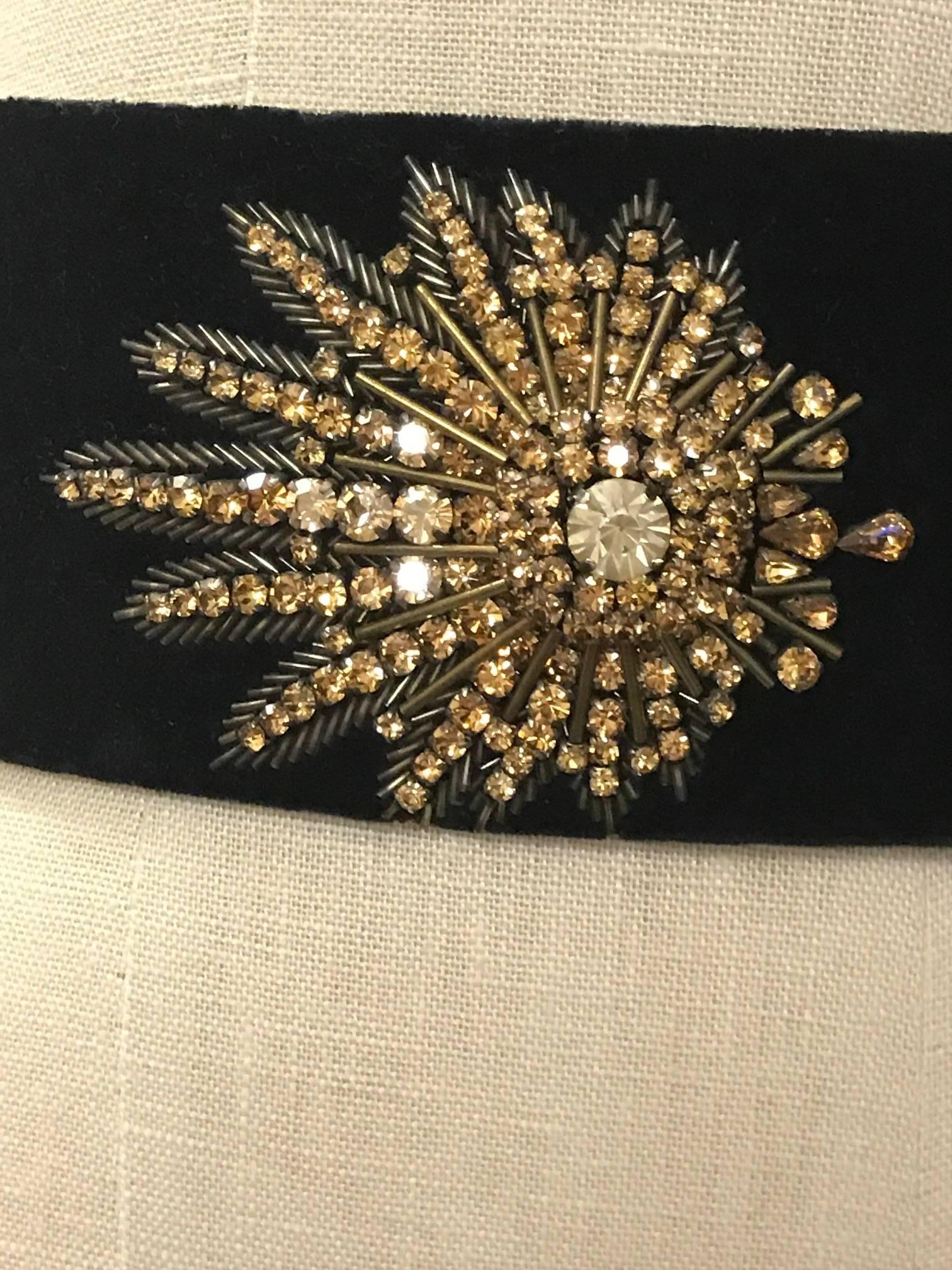 Alexander McQueen black velvet wide waist belt with goldtone crystal and beaded embellishment at front. Fastens at back with three hidden snaps.

Labelled size 28, but runs small, see measurements.
2 7/8" wide.
Approximately 26 3/4" around