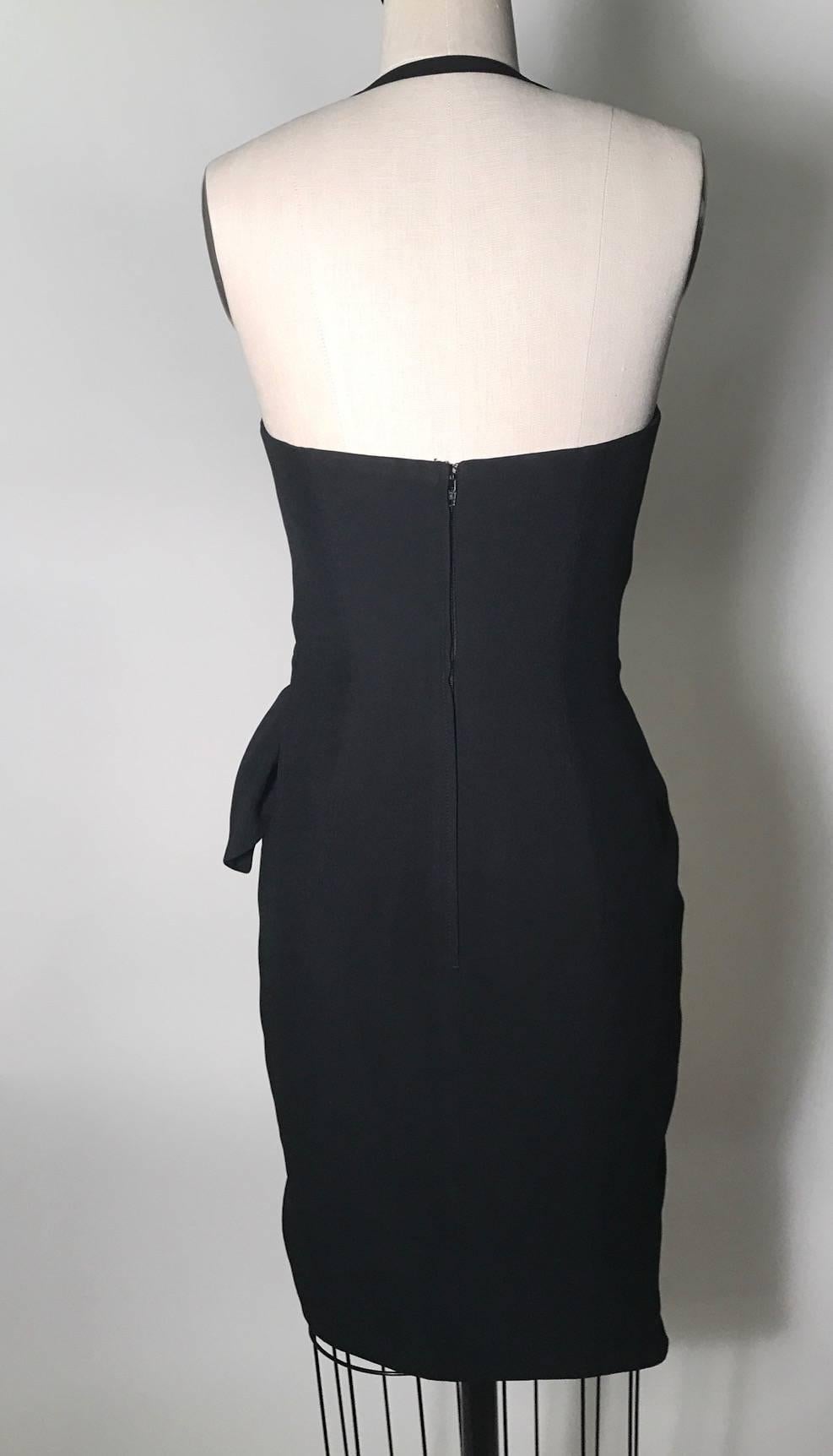 Moschino Couture from the Cruise Me Baby collection 1990's little black dress with halter strap and wrap waist. Boning at sides, padding at bust. Back zip and hook and eye.

Also looks cool left unwrapped in an asymmetrical tunic style paired with a