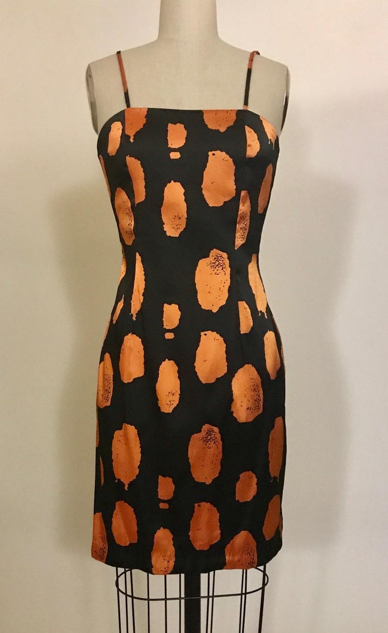 1988 Stephen Sprouse black and orange fitted paint dot pencil dress from his Sprouse line. Back zip and hook and eye.

100% polyester.

Labelled size 4, see measurements. Some stretch, measurements unstretched.
Bust 31