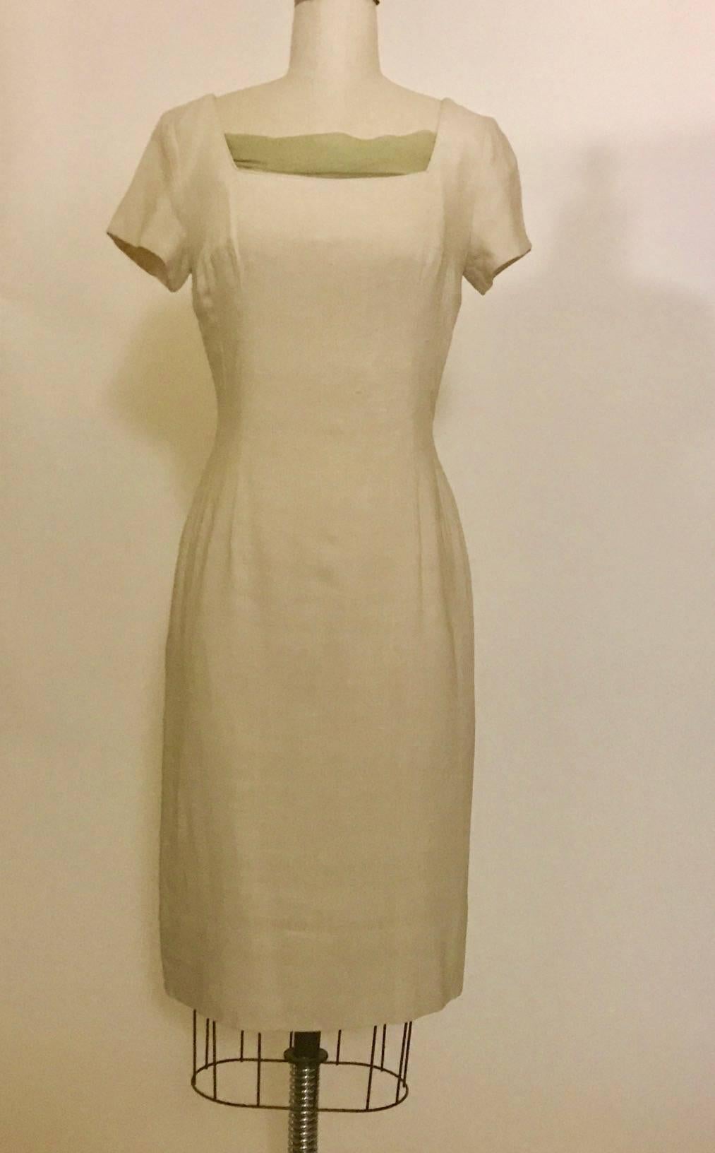 Late 1950s or early 60s Mr. Blackwell silk shift dress in a dark cream/natural color. Square neck, short sleeves. Back metal zip with tiny bow at top. 

No garment label, feels like mid-weight silk. Natural slubs throughout. 

No size label, best