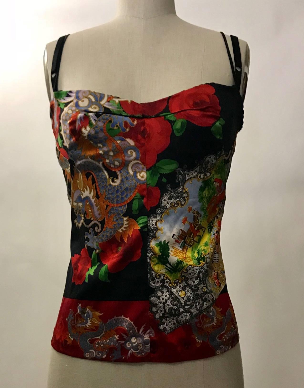 Dolce & Gabbana red top featuring dragon and rose print. Built in mesh bralette with scalloped edging at top (straps meant to be exposed.) Fastens along back with hook and eye closures.

Silk/stretch blend.

Made in Italy.

Size IT 44,
