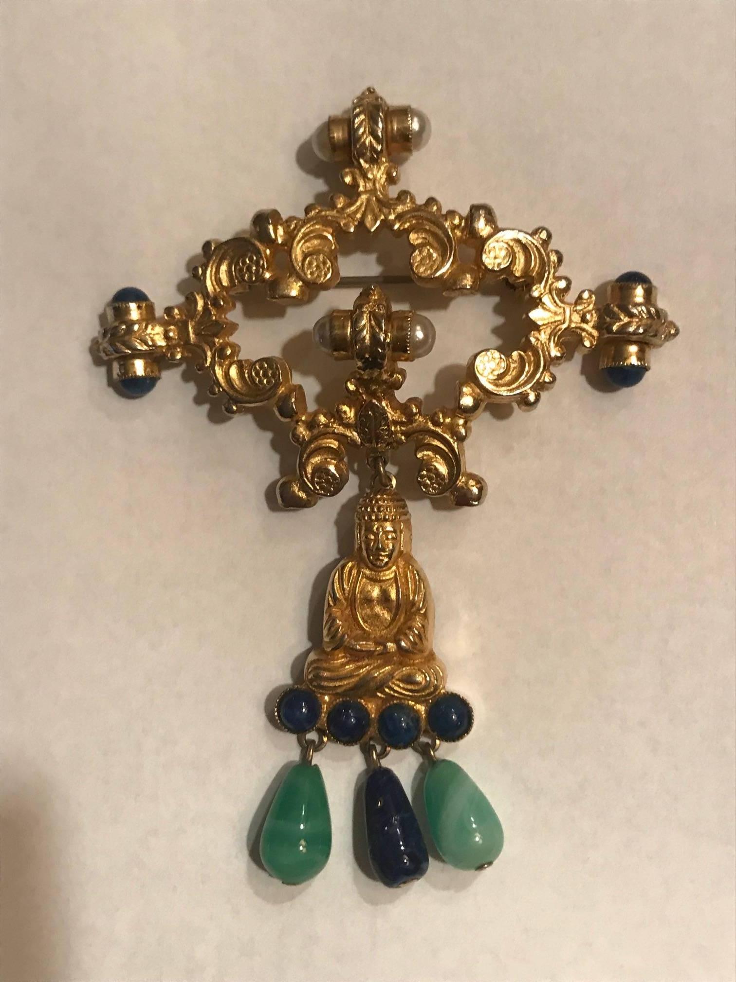 William de Lillo vintage 1960s (1968) gold tone Buddha pin and earclips. Accented with faux pearl, jade, and lapis. 

Stamped WM de Lillo at back of one earring and at back of brooch.

Pin fastening on brooch, clip fastening on earrings.

Brooch