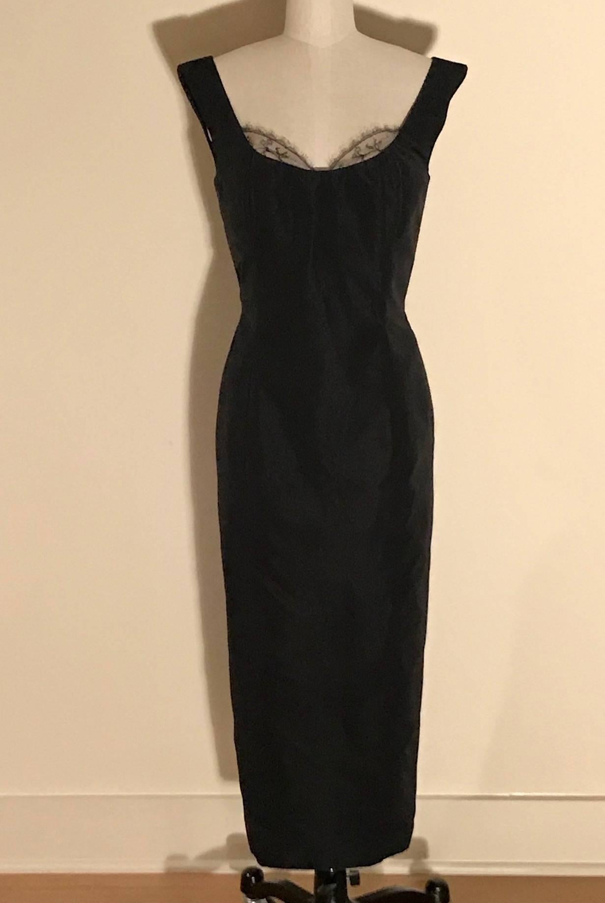 Alexander McQueen black silk dress from the 2005 Hitchcock inspired collection 'The Man Who Knew Too Much,' which channeled Tippi Hedren and Marilyn Monroe. Fitted midi length silhouette with lace accent at bust. Boned at upper bodice. Back zip and