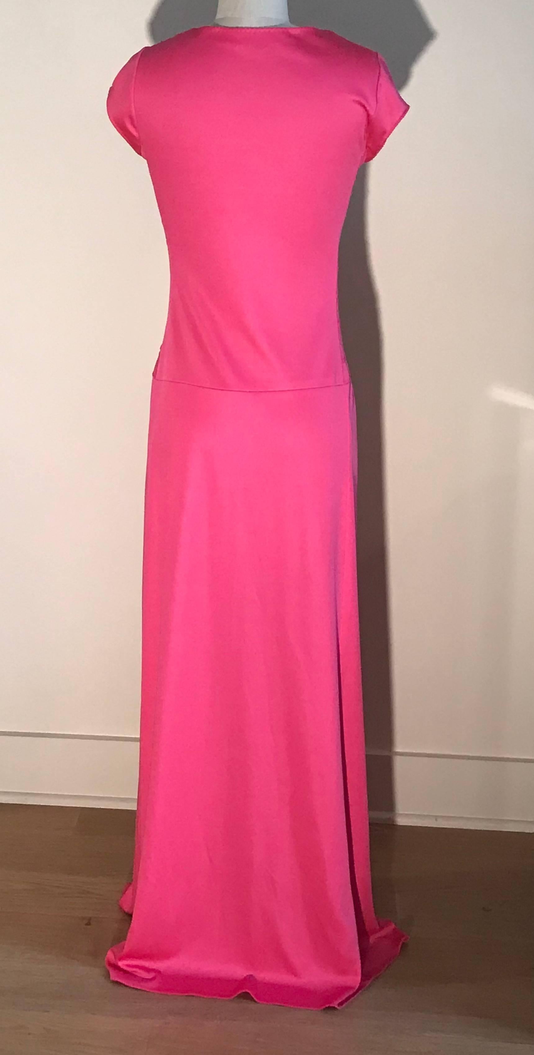 Stephen Burrows vintage 1970s pink maxi dress with scoop neck, cap sleeves,  and zig zagging strip detail at bodice. Signature lettuce edge at neck, hem, and cuffs. Skirt is an overlapping faux wrap style with a slit all the way up to expose a bit