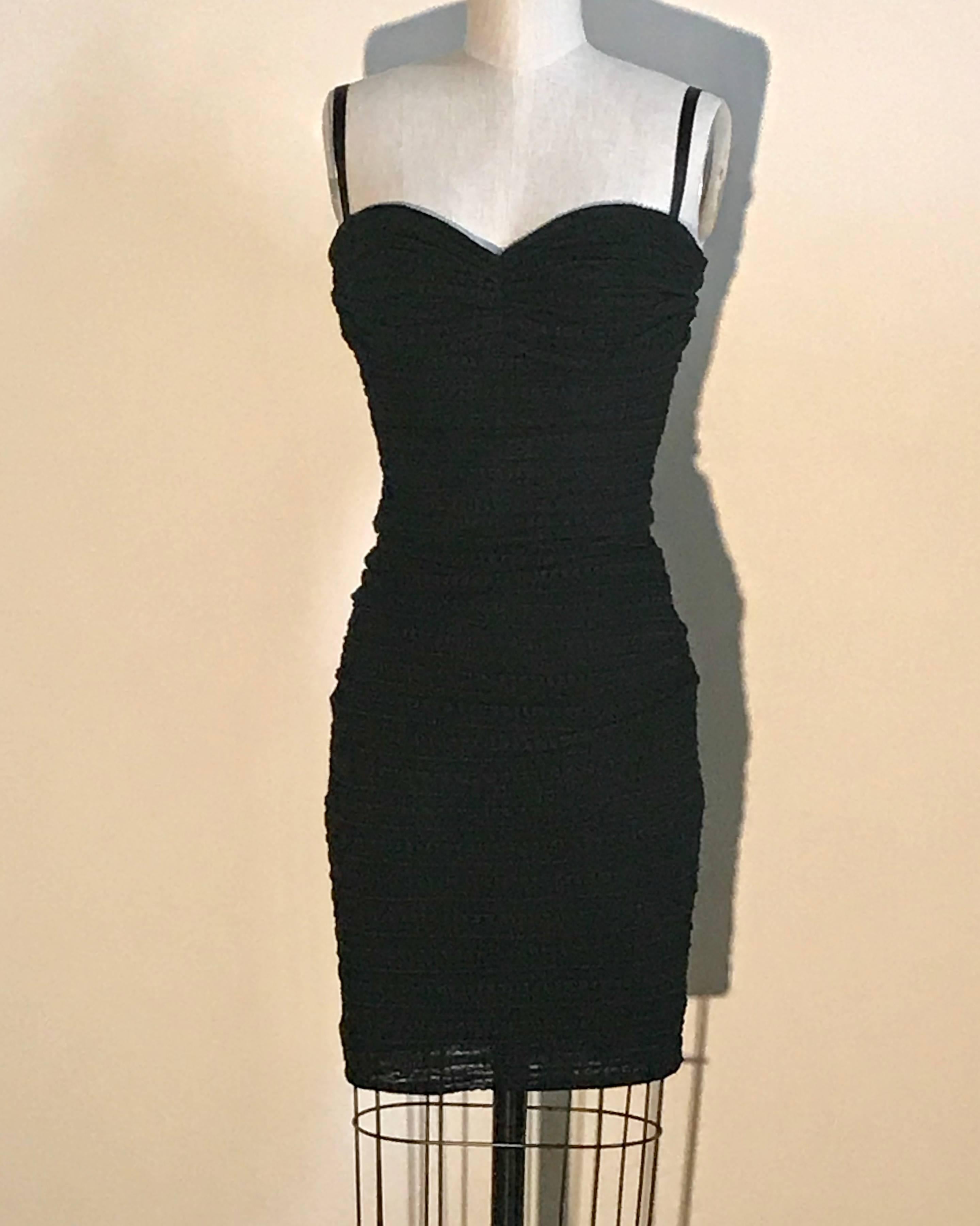 Dolce & Gabbana sexy little black dress in an amazing textured stretch fabric with slight draping/ruching at bodice. Can be worn with ribbon straps, or they can be tucked in and it can be worn strapless. Built in bustier with boning and cups at