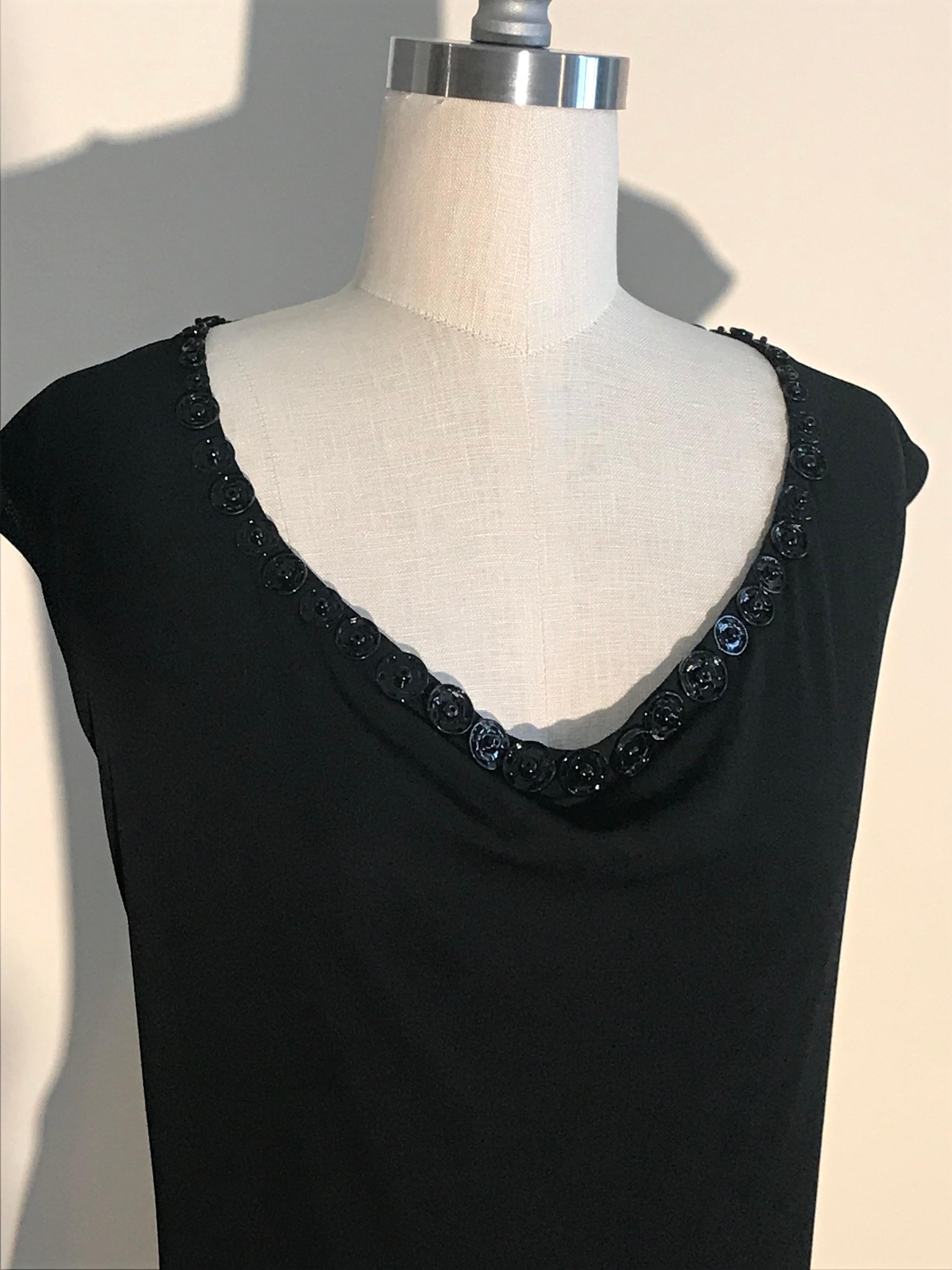 Jean Paul Gaultier Femme 2000s little black jersey sleeveless dress with various sized black metal snap embellishments around neck. Pulls on overhead.

100% rayon.
Fully lined in 92% polyamide, 8% elastane.

Made in Italy.

Labelled size IT 42, US