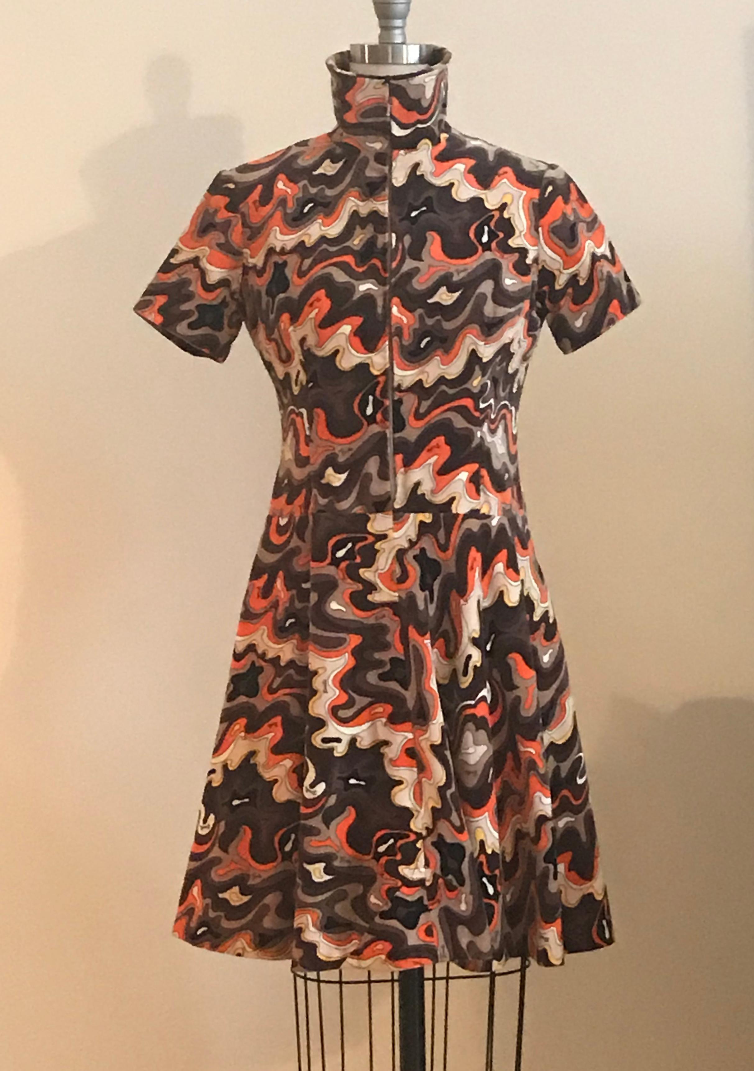 Emilio Pucci for Saks Fifth Avenue 1960s fit and flare velvet dress in orange, brown, and tan signature print. Short sleeves. Zipper closure at front with an amazing collar that can be worn zipped up turtle neck style or unzipped for a basic collar
