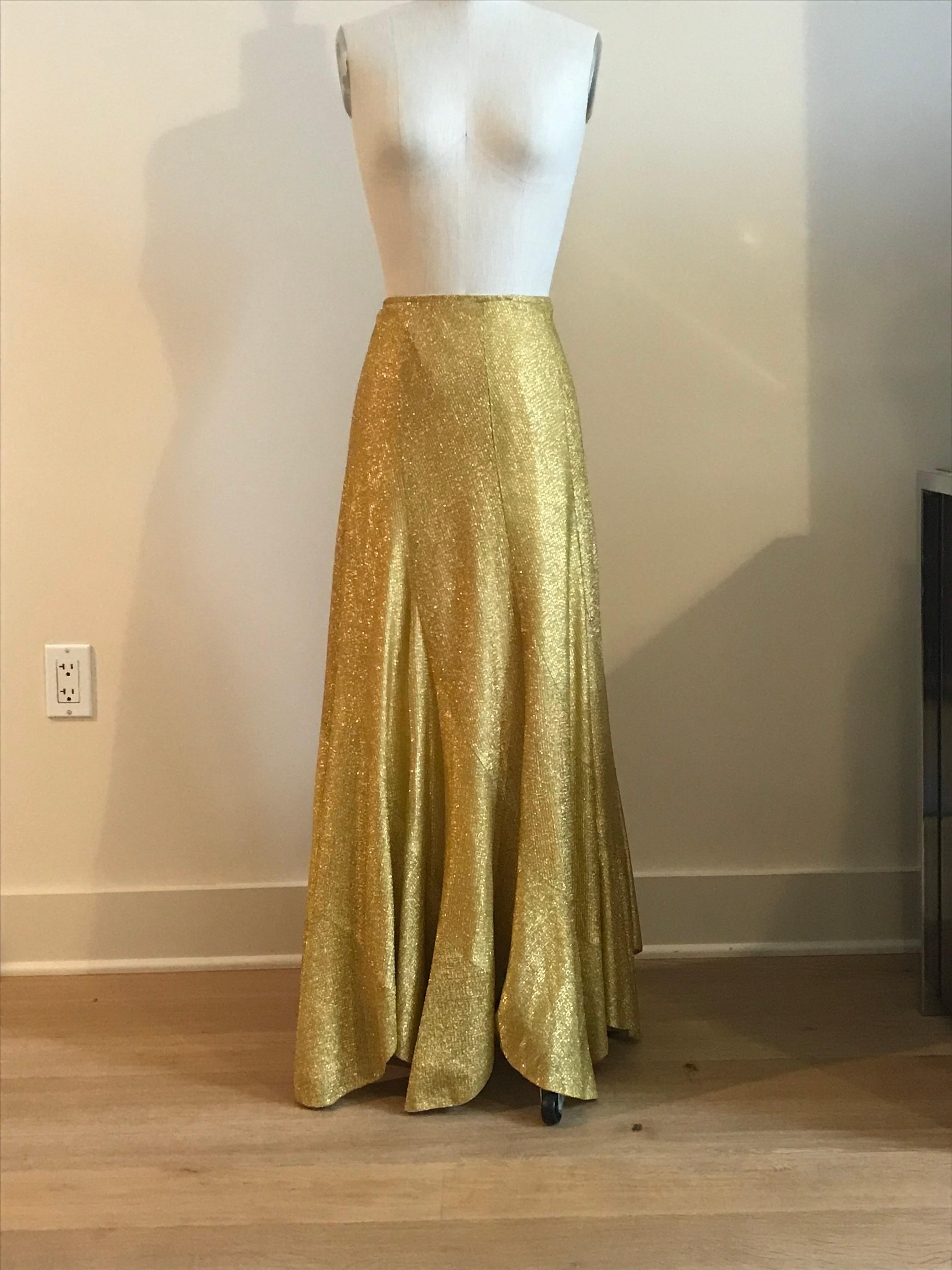 Vintage 1960s or 70s metallic gold maxi skirt by Beverly Paige. Side zip.

Pair with a silk camisole for a night out, or top with an oversized t-shirt and wear with a pair of sneakers for a funky day time look.

Content unknown. Fully lined.

Made