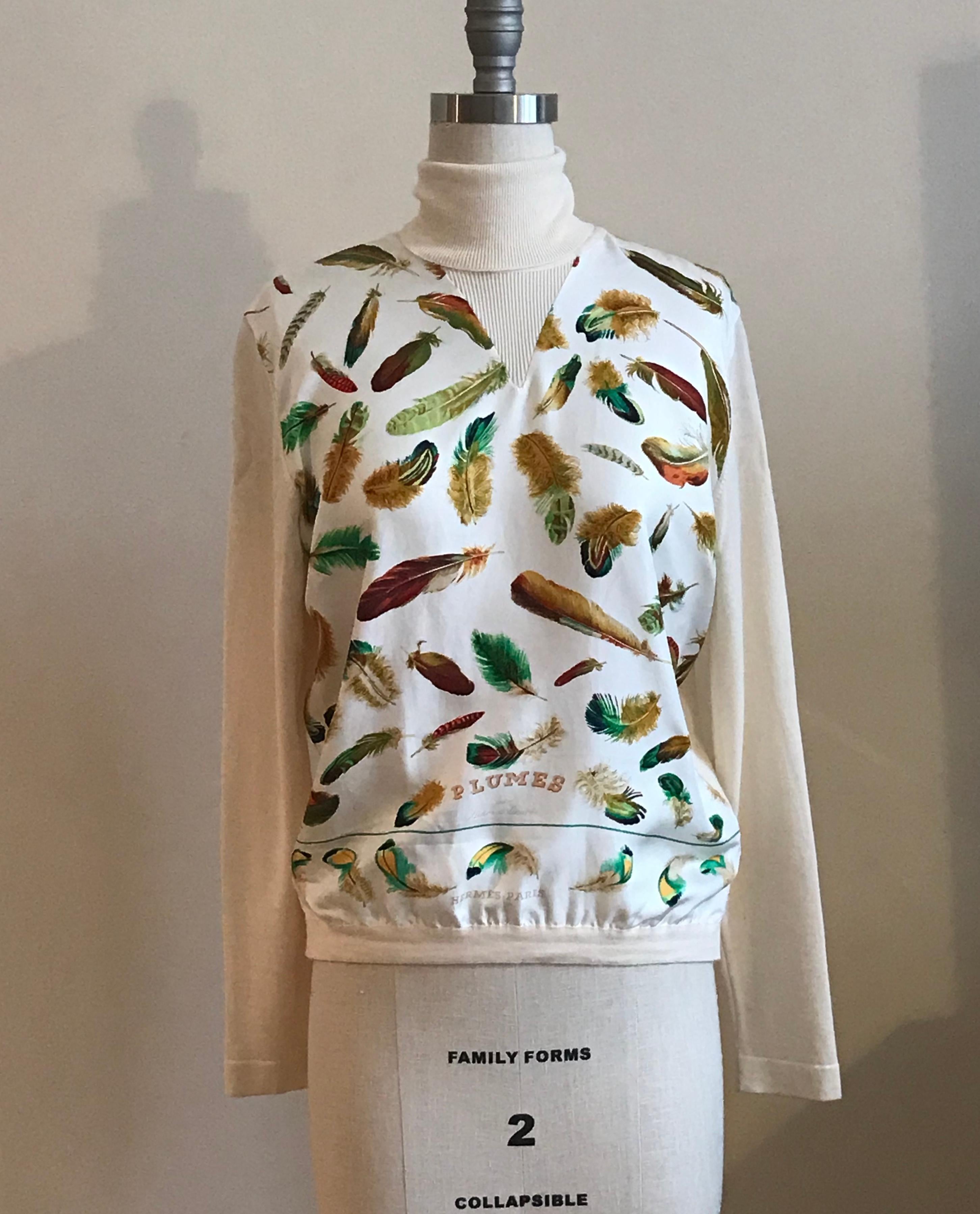 Very rare vintage Hermes Paris Cream knit long sleeve turtleneck sweater with ivory silk scarf print front featuring green, gold, and brown feathers. Front bottom reads PLUMES, par Henri de Linares, HERMES-PARIS.

100% silk front with 100% wool fine