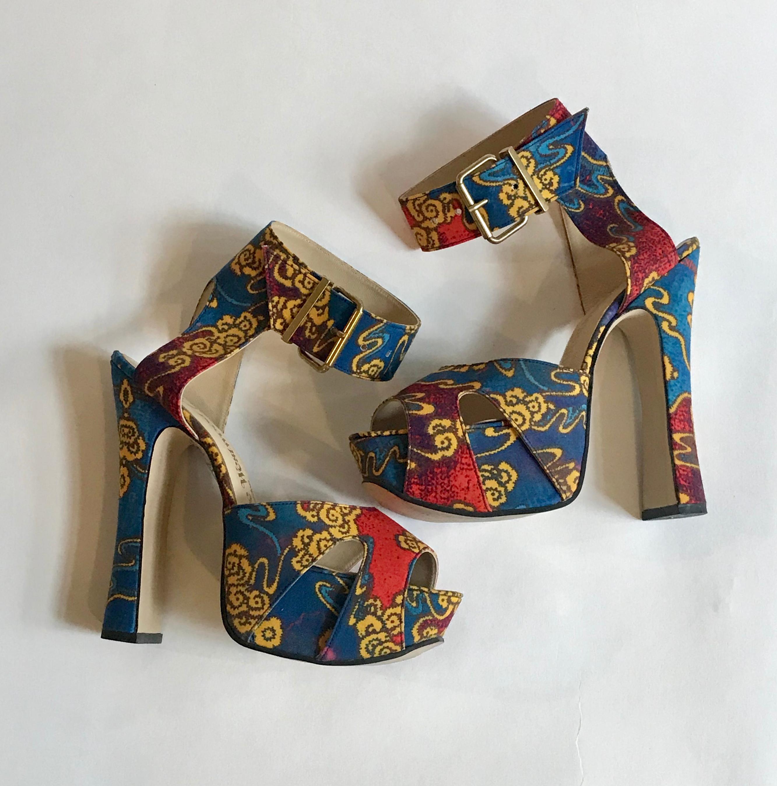 Rare Vivienne Westwood Elevated Slave style sandal in the designer's iconic blue, red, and gold Tea Garden print. Buckles at ankle strap. Chunky heel with an elegant curve measures 6 3/4