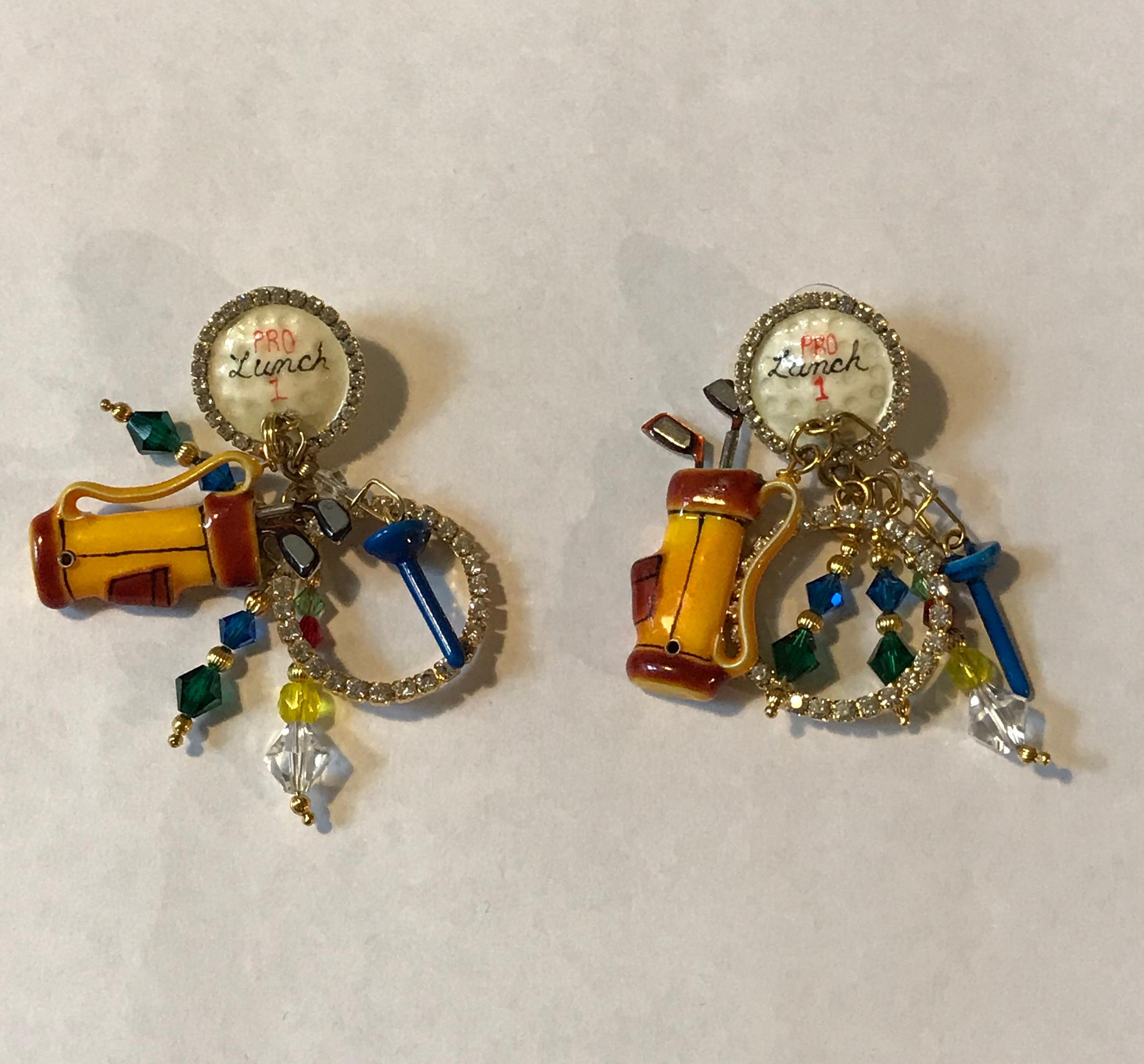 Lunch at the Ritz vintage 1990s gold tone golf theme earrings featuring enamel and rhinestone detail and beads. These over the top golf themed costume jewelry earrings feature a golf ball reading 'Pro Lunch 1' encircled in rhinestones, with dangles