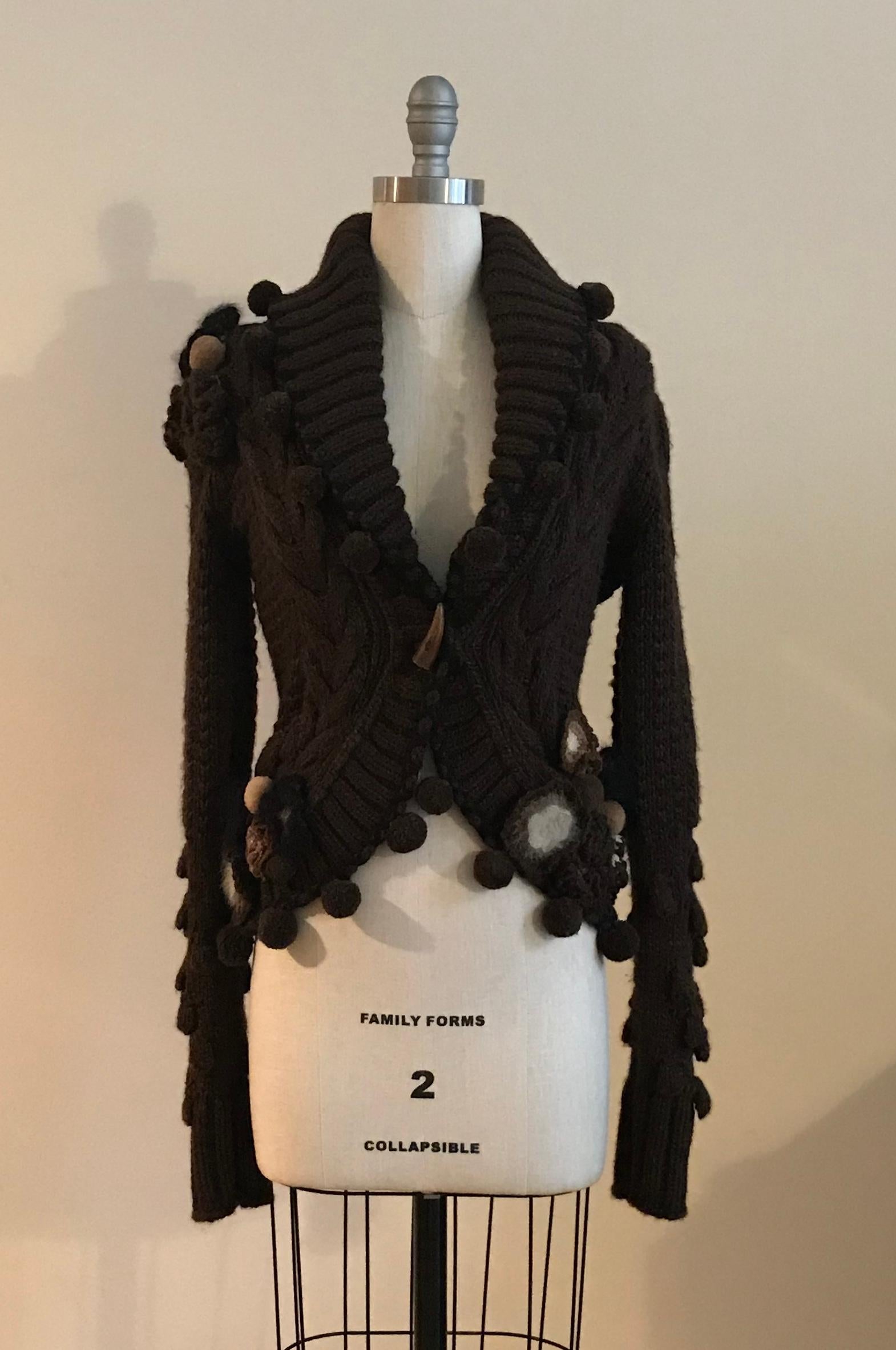 Alexander McQueen chunky brown knit cardigan style sweater with pom pom detail as seen in his Fall 2005 runway presentation, The Man Who Knew too much, based on the Hitchcock film, Marilyn Monroe, and Tippi Hedren (look 12.) Sweater features an