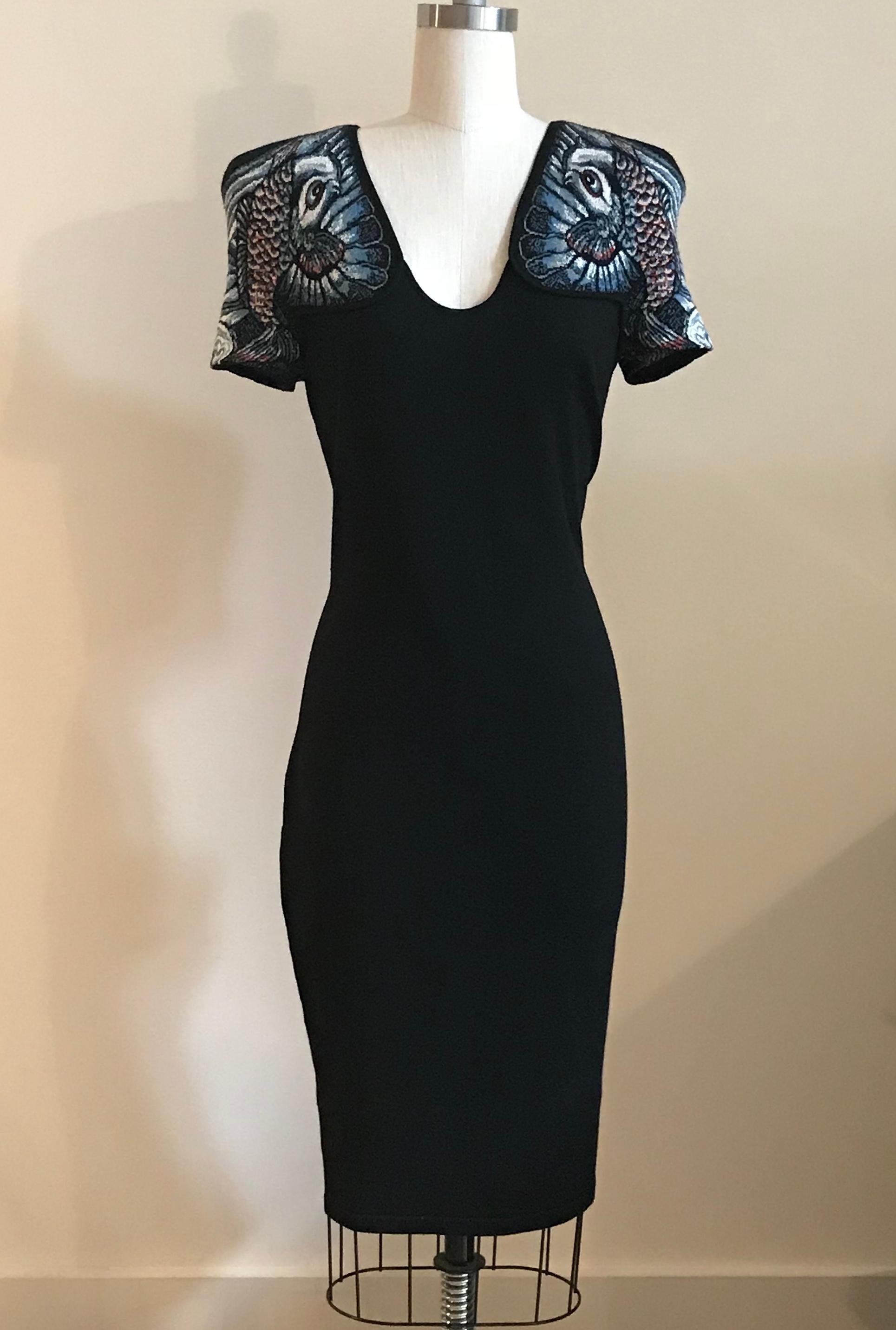 Alexander McQueen rare 2011 fine knit black dress featuring beautiful blue koi fish design at shoulders. Scoop neck, light shoulder padding. Pull-on, no closure. 

Main fabric: 89% wool, 11% nylon. 
Jacquard insets: 71% cotton, 29% silk.

Made in