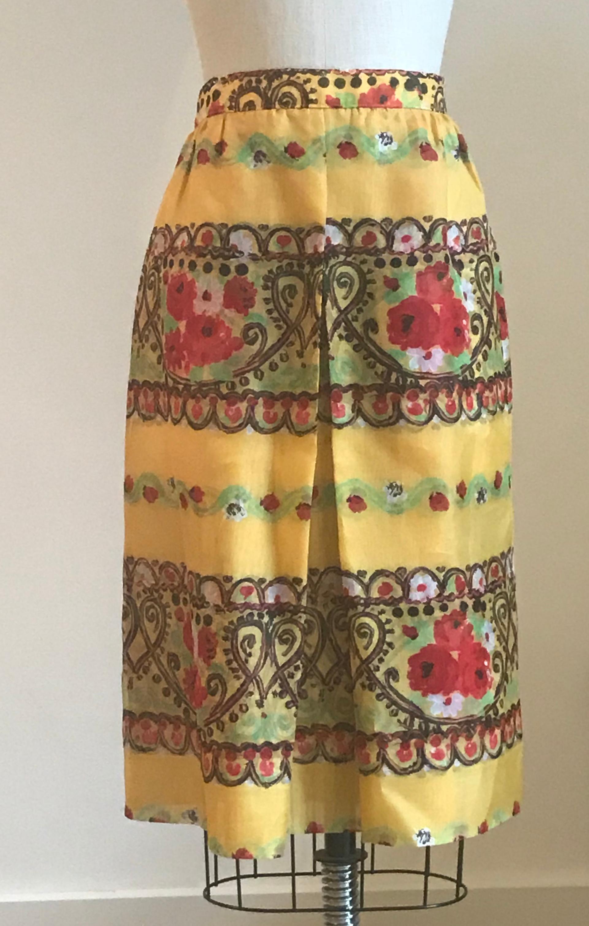 Christian Lacroix yellow skirt made of two layers of semi-sheer painterly printed silk featuring heart and floral pattern. Black panel at one side of back waist. Back zip and button.

100% silk.

Made in France.

Labelled size FR 44, approximate US