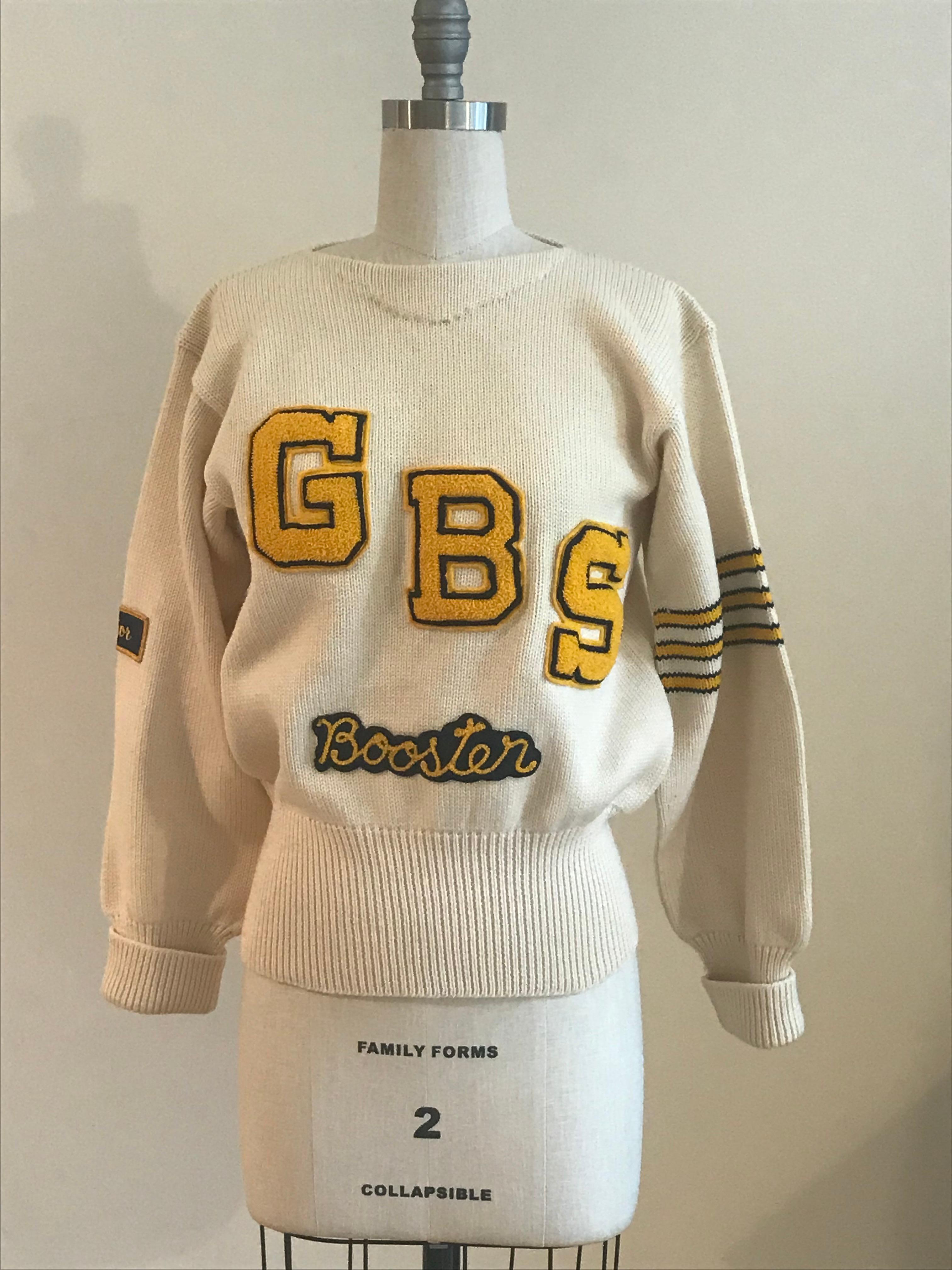 Logan Knitting Mills vintage 1950s letter sweater with yellow and navy chenille lettering reading GBS Booster. 'Senior' Patch at sleeve, with yellow and navy stripe at opposite sleeve. Rib knit trim at waist and cuffs. 

100% wool.

Made in