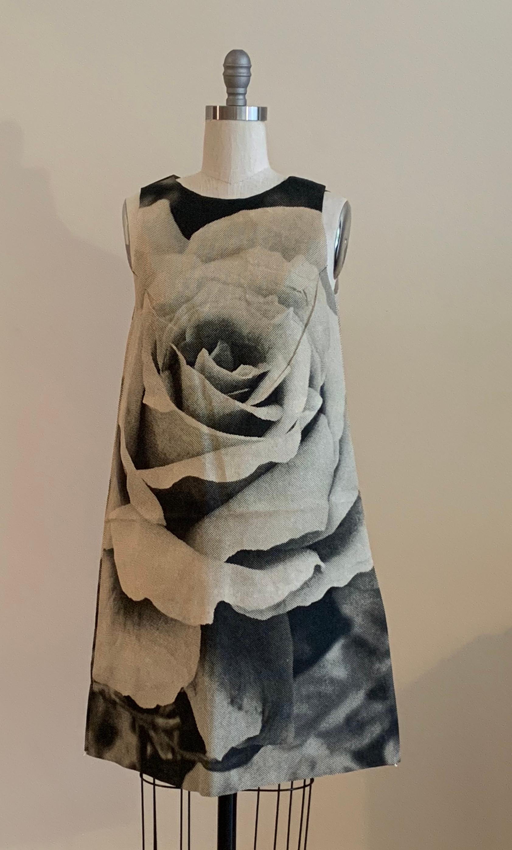 Iconic 1960's disposable paper rose dress by Harry Gordon. Black and white newspaper style poster print dress features a huge newspaper print rose. This dress is one of a set of five created by Gordon, and the dresses are featured in the collections