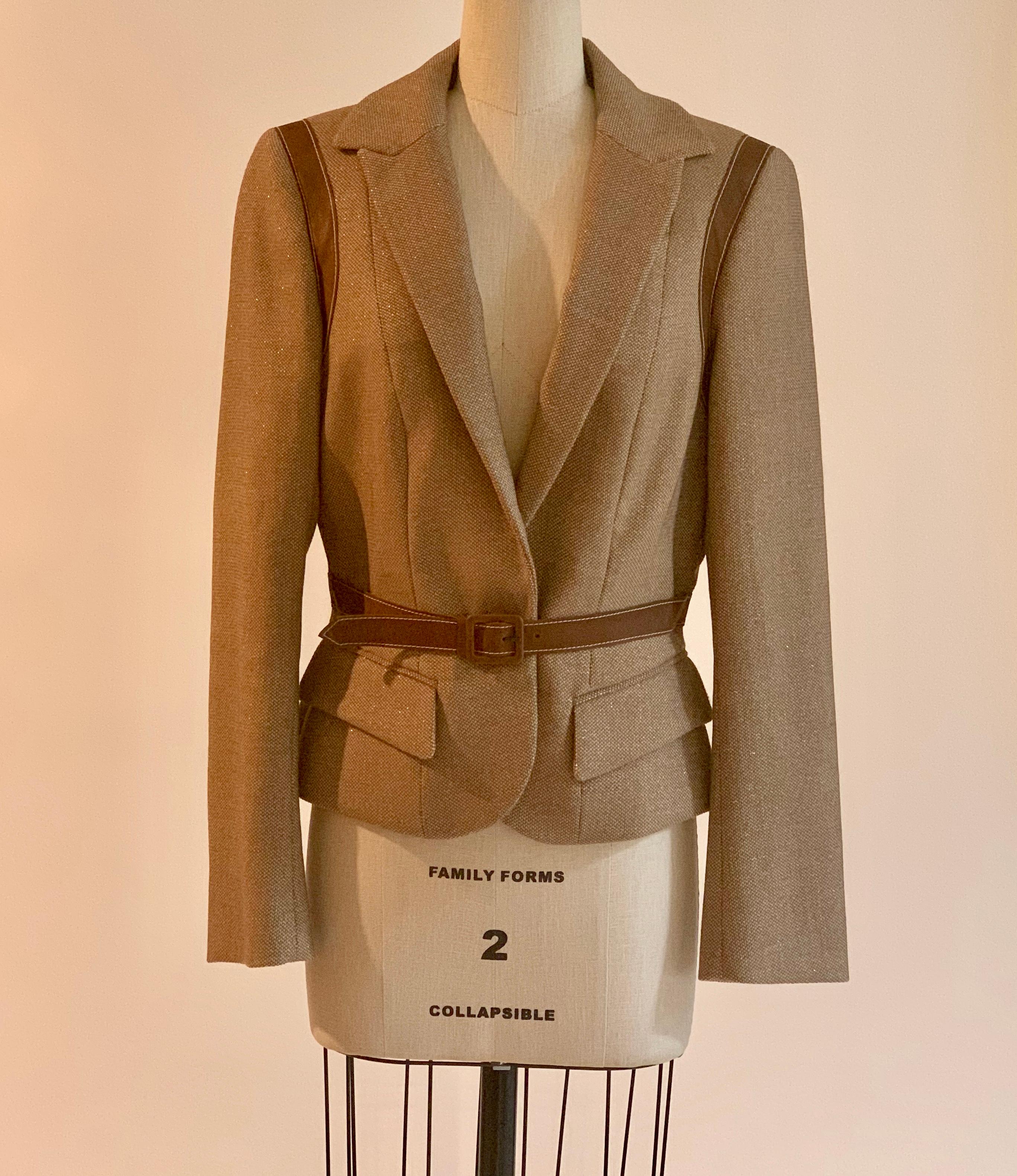 Alexander McQueen 2007 tan blazer with metallic specks throughout weave and leather straps that come over shoulders and criss cross at back, closing in a buckled belt front at front waist. 

92% wool, 4% polyamide, 4% leather. 

Made in Italy.