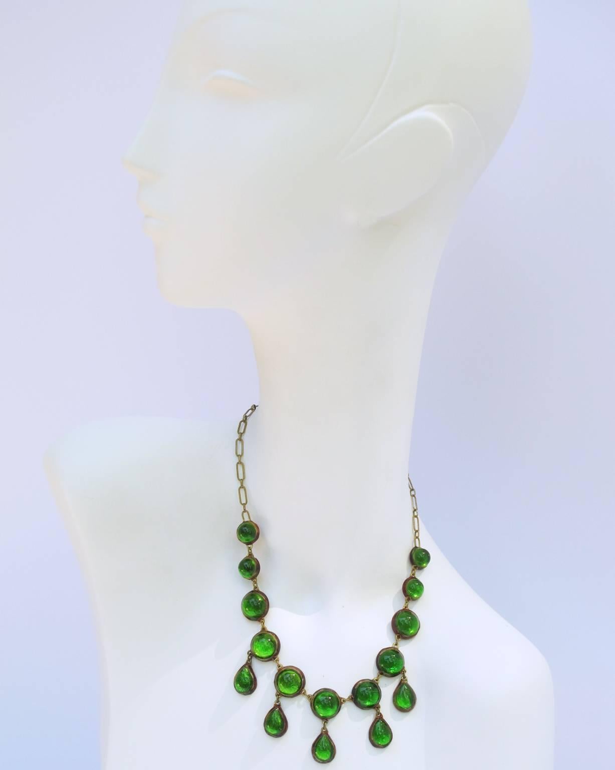 Vintage 1960s Talosel Necklace executed by one of the student of Line Vautrin. Brown talosel resin geometric dangling shape with charms, encrusted with green cabochon on silver foil background. Gilt metal chain with hook that can be adjusted for