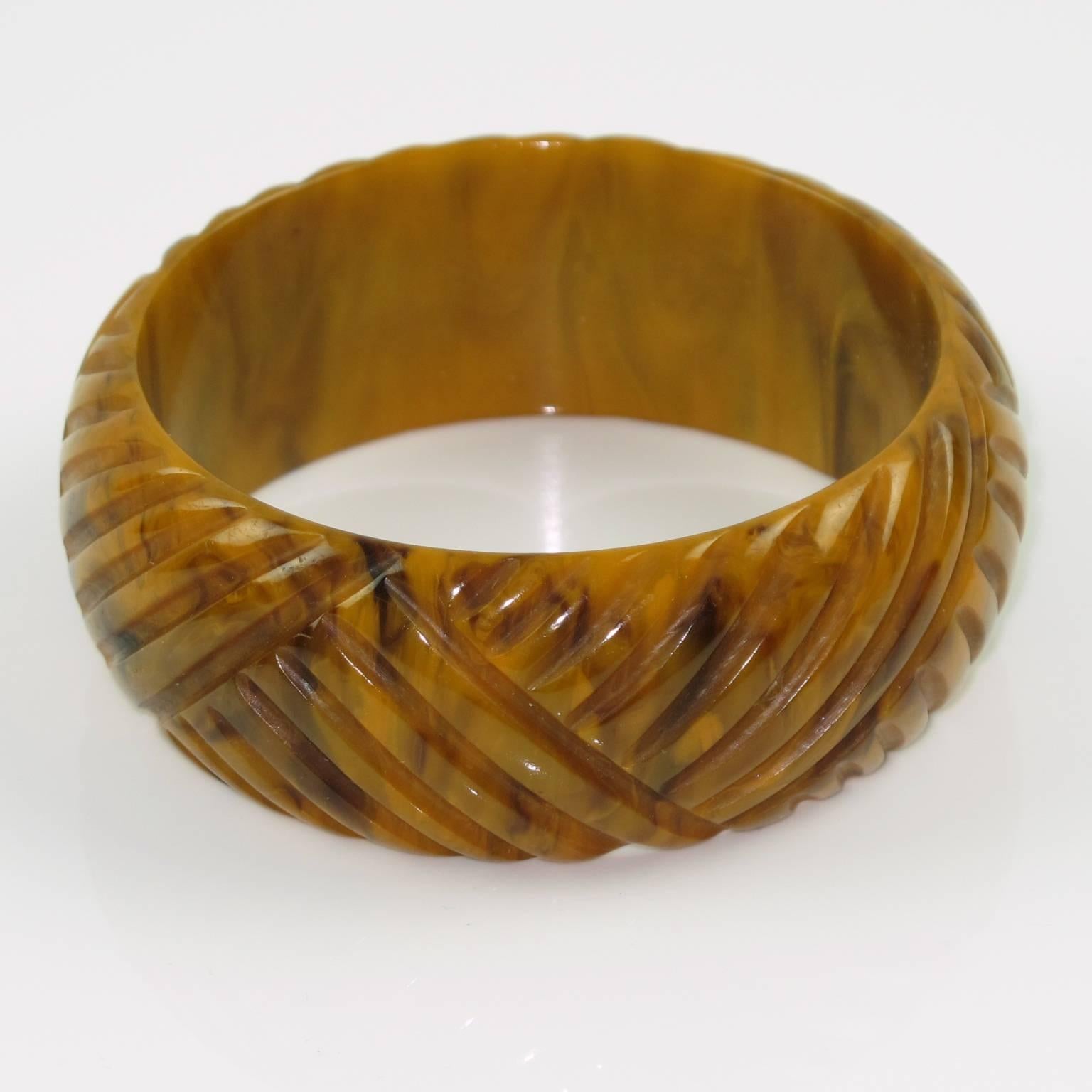 Vintage chocolate sundae marble Bakelite carved bracelet bangle. Domed shape with deep geometric carving all around. Intense chocolate marble tone with gold and brown cloudy swirling. Excellent vintage condition. France, circa