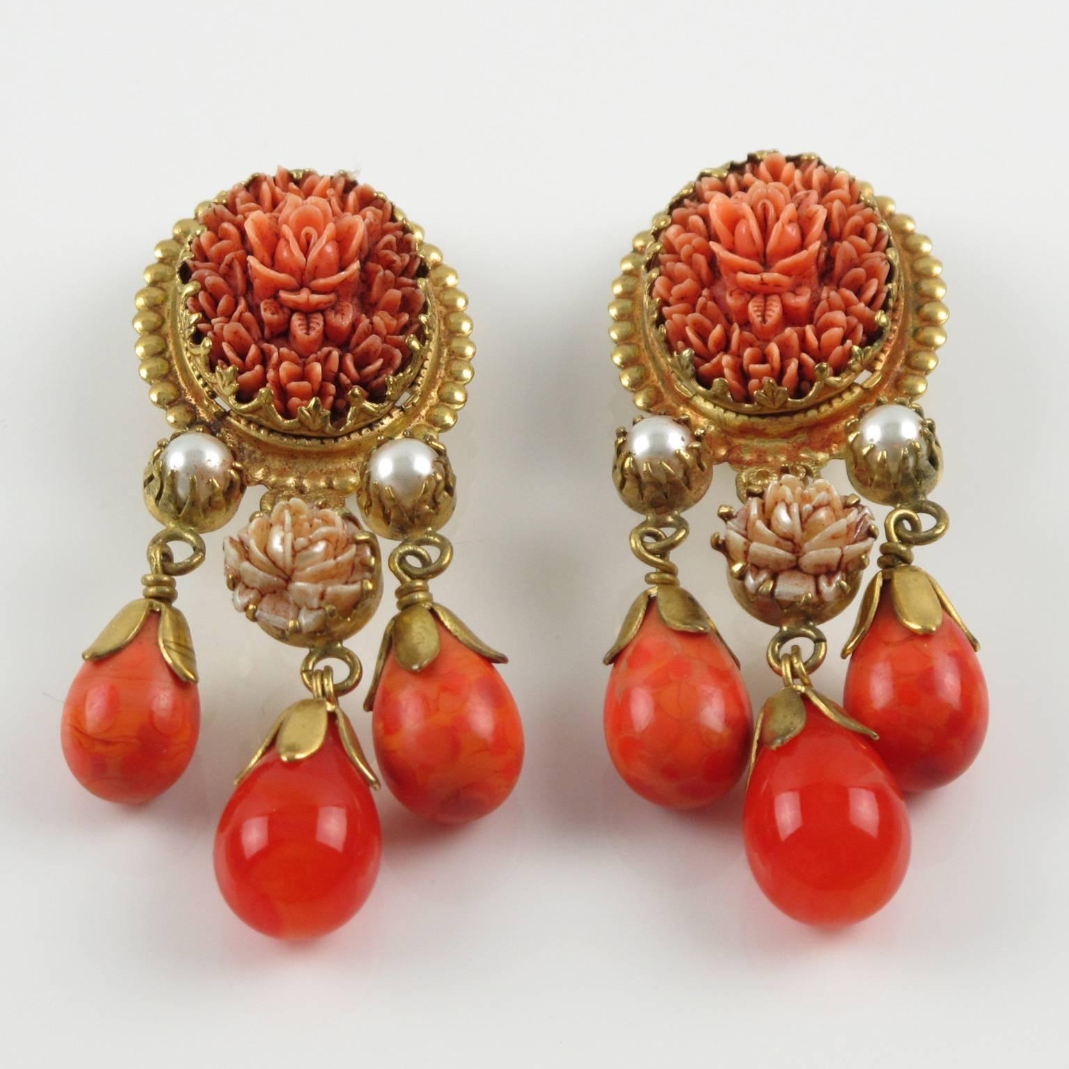 Vintage early 80s French GAS ST TROPEZ clip on earrings. Fabulous dangling shape with baroque style featuring gilt metal frame, metal all textured, ornate with charm poured glass drop beads in warm orange tone and topped with simulated pearl, and