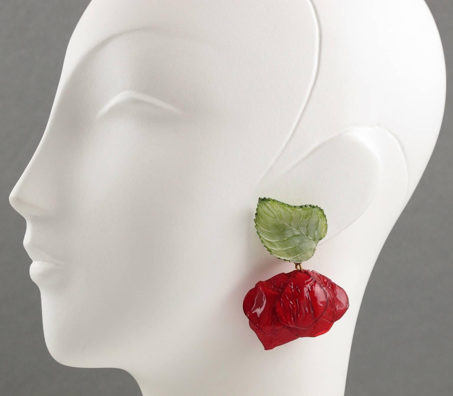 Vintage French Jewelry Designer FRANCOISE MONTAGUE Paris clip on Earrings. Elegant large dangle shape, in resin or talosel, featuring dimensional rose flower with leaf in assorted tones of bright red and tender green and clip back. Excellent vintage
