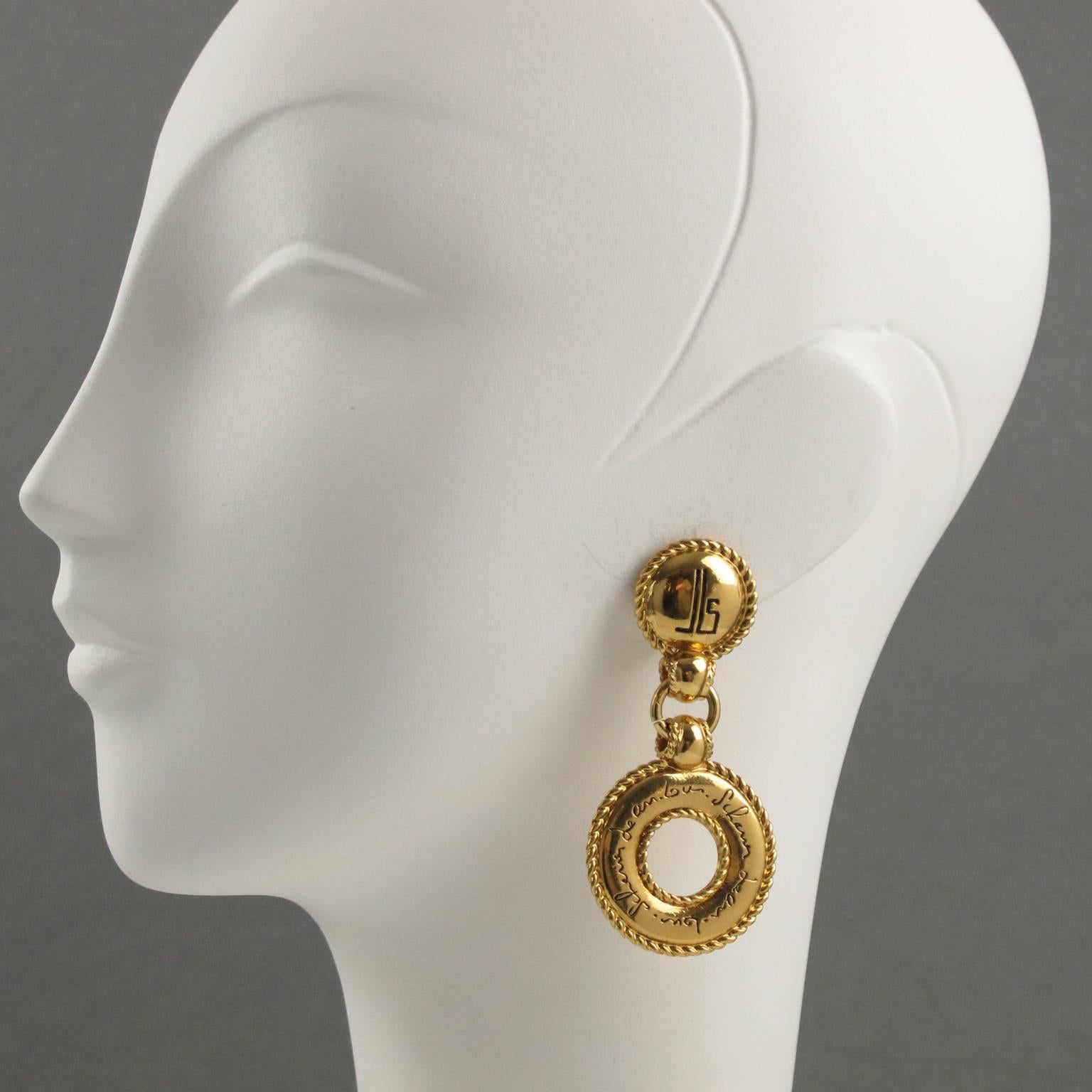 French Jewelry designer JEAN LOUIS SCHERRER Paris signed clip on earrings. Couture dangling shape, shinny gilt metal with carving, see thru and texture ornate with black contrasted engraved brand logo and hand-written signature brand and clip back.