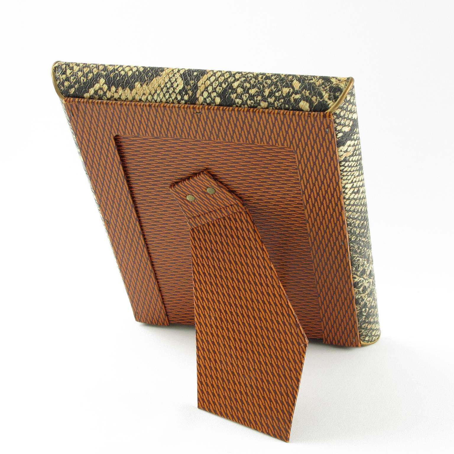 Vintage Mid Century Modern French vanity picture photo frame. Decorative imitation leather frame with textured faux python snake skin pattern and brass deco accents. Easel at the back. Frame can be placed in portrait or in landscape position.