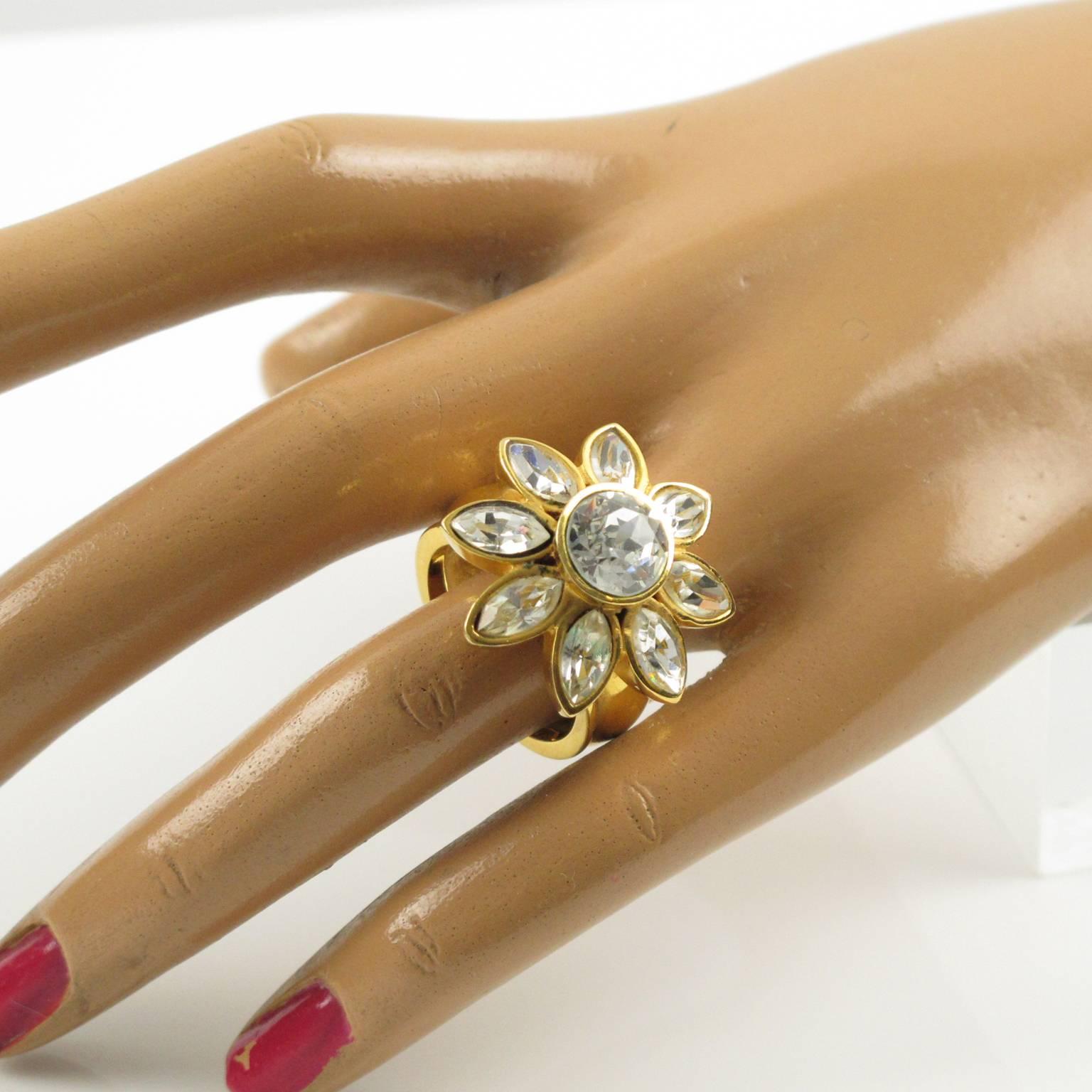 Jeweled cocktail ring by YVES SAINT LAURENT, YSL Paris. Floral shape with large band in gold plated metal ornate with rhinestone in pear shape, crystal clear color. Signed in the inside "YSL". Excellent pre-owned vintage condition, France,