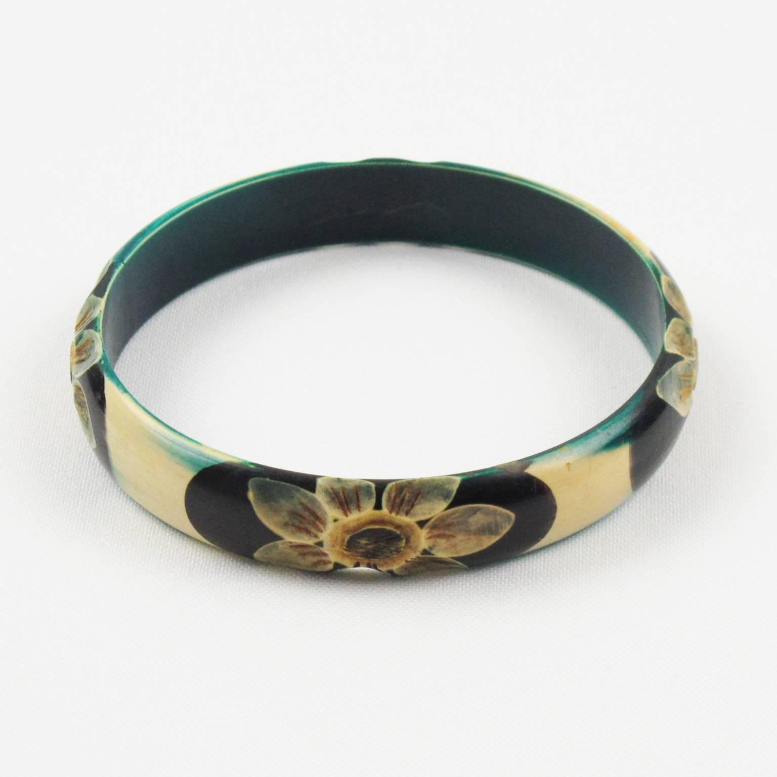 Lovely vintage Art Deco celluloid bracelet bangle. Featuring floral design, four motif all around the bracelet deeply carved, painted and stained. Assorted colors of teal, off-white, yellow and black. France, circa 1925s. Excellent vintage
