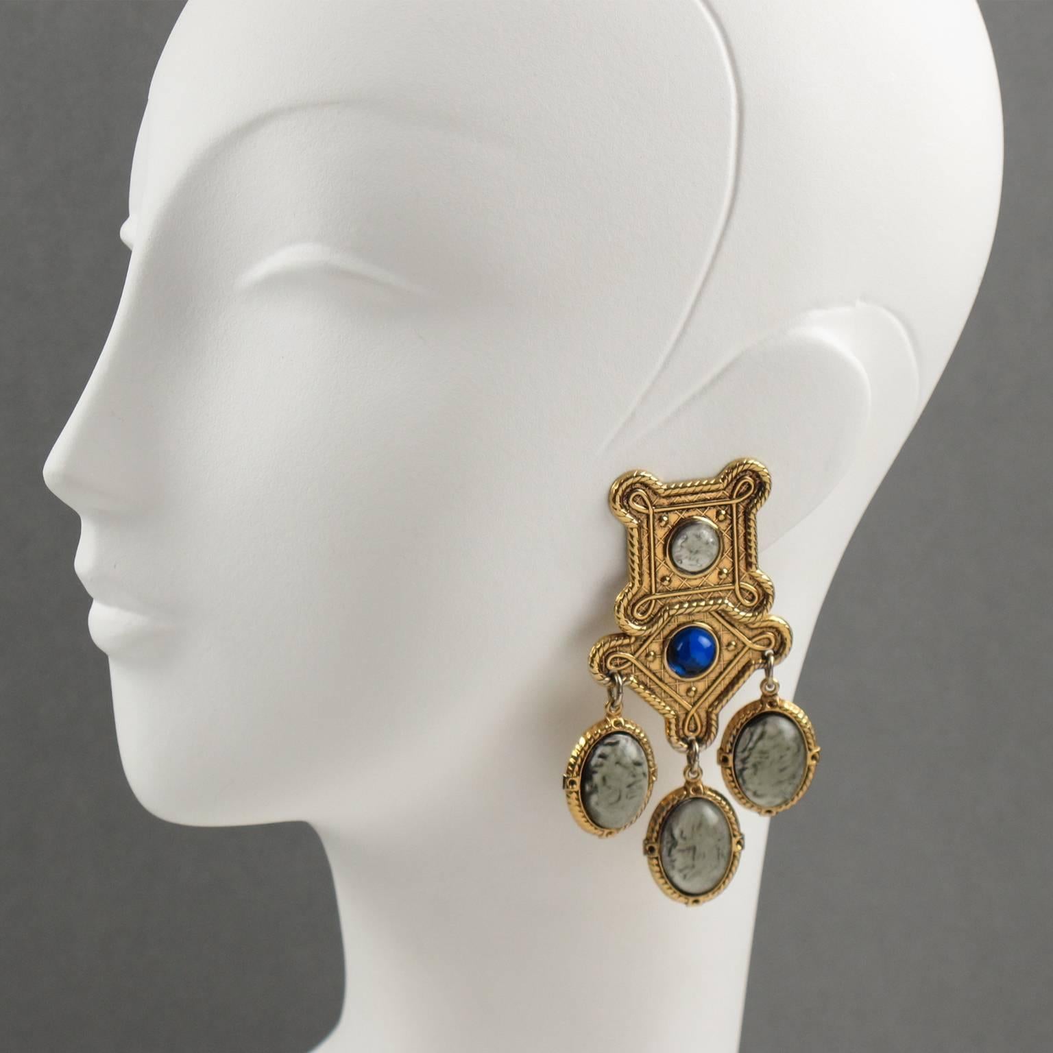 Rare vintage 1980s Zoe Coste Paris baroque dangling clip on earrings. Huge chandelier earrings featuring Byzantine style design, gilt metal all textured and ornate, topped with cobalt blue resin rhinestone and compliment with Gripoix moon-glow gray