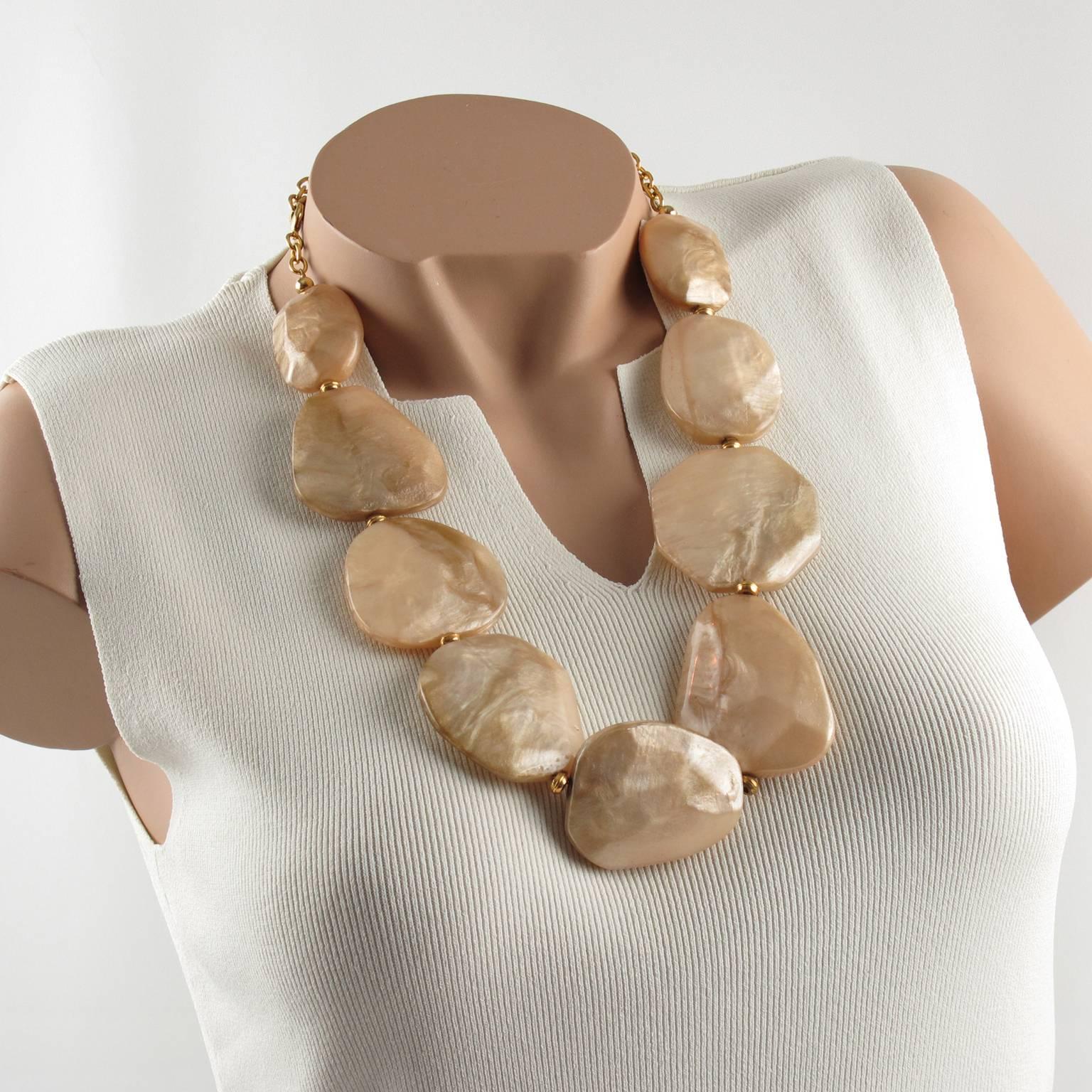Impressive Dominique Denaive Paris signed Necklace. Sculptural huge choker necklace build with textured resin pebble shaped elements in lovely light peach color with moon-glow textured pattern. Gilt metal chain for length flexibility. Signed on