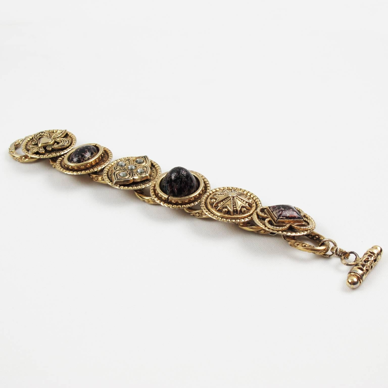 1980s rare Zoe Coste Paris Medieval link Bracelet. Heavy antique gilt metal link shape topped with textured metal coin style elements and compliment with Gripoix poured glass cabochon in unusual black and dark red marble color with pearlized