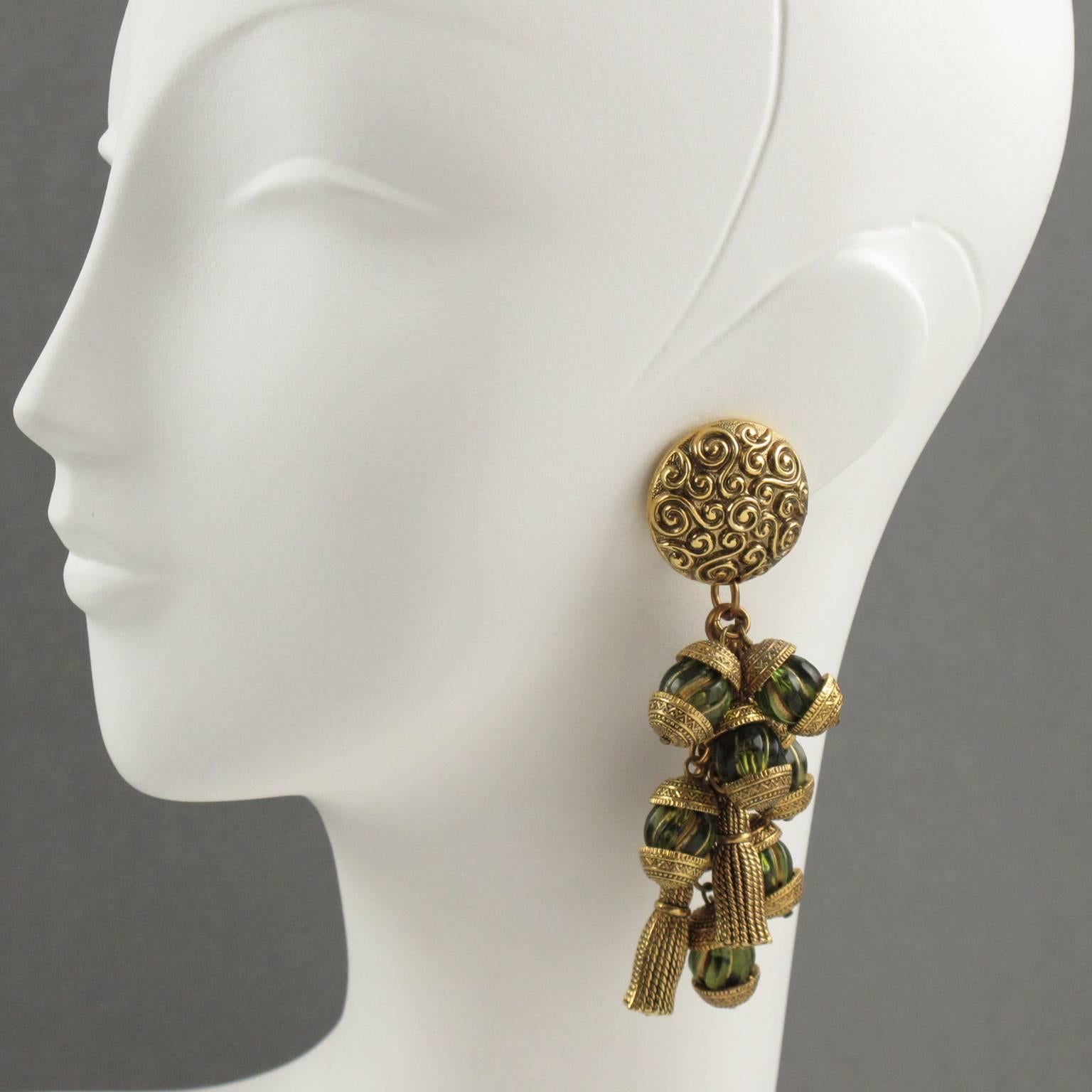 Stunning French Designer CHANTAL THOMASS Paris clip on earrings. Rare gorgeous dangling chandelier shape, featuring cluster of gilt resin carved tassels and transparent green resin beads with gilt accent. Unmarked. Excellent vintage condition.